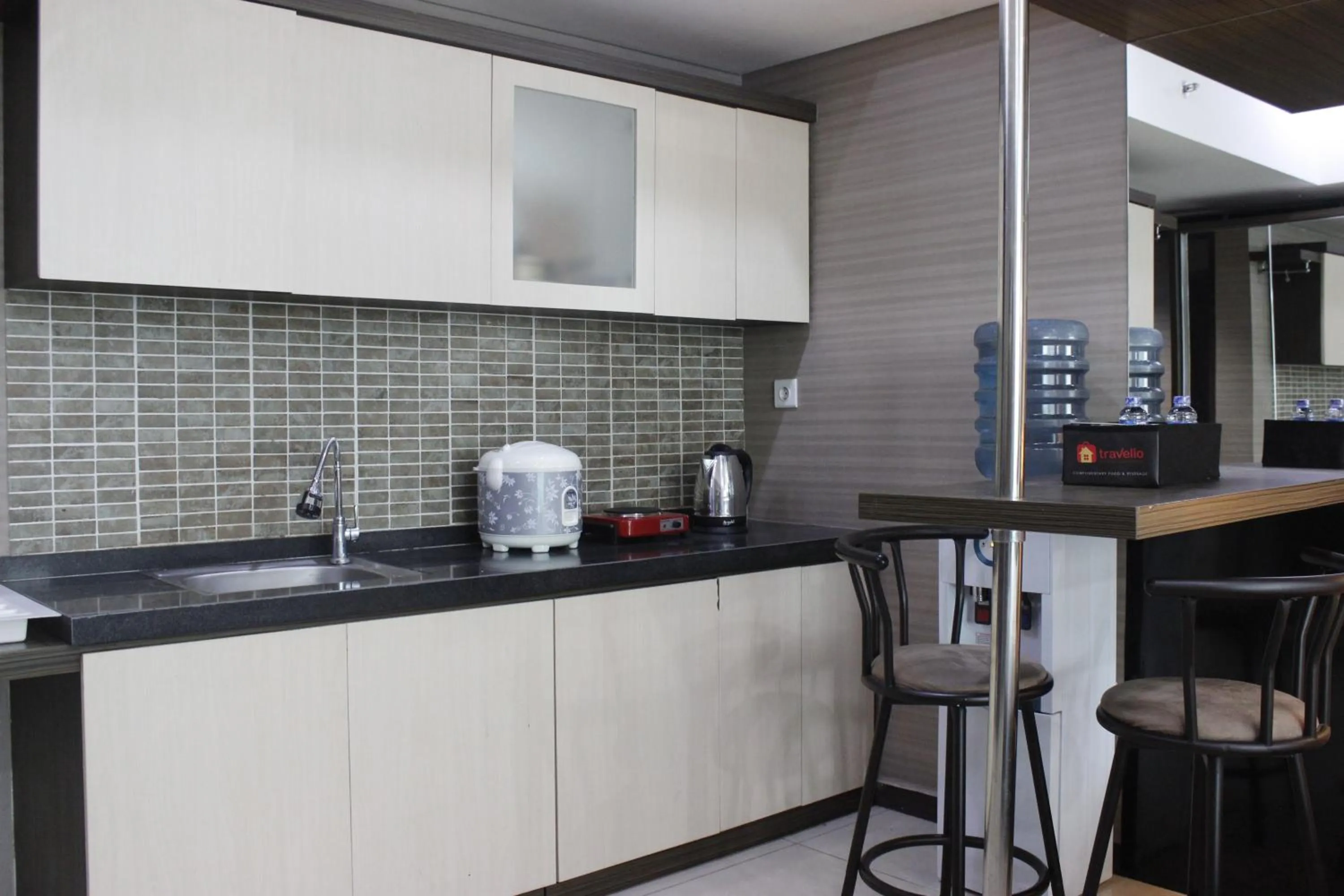 Kitchen or kitchenette in Prime and Comfy Studio at Tamansari La Grande Apartment By Travelio