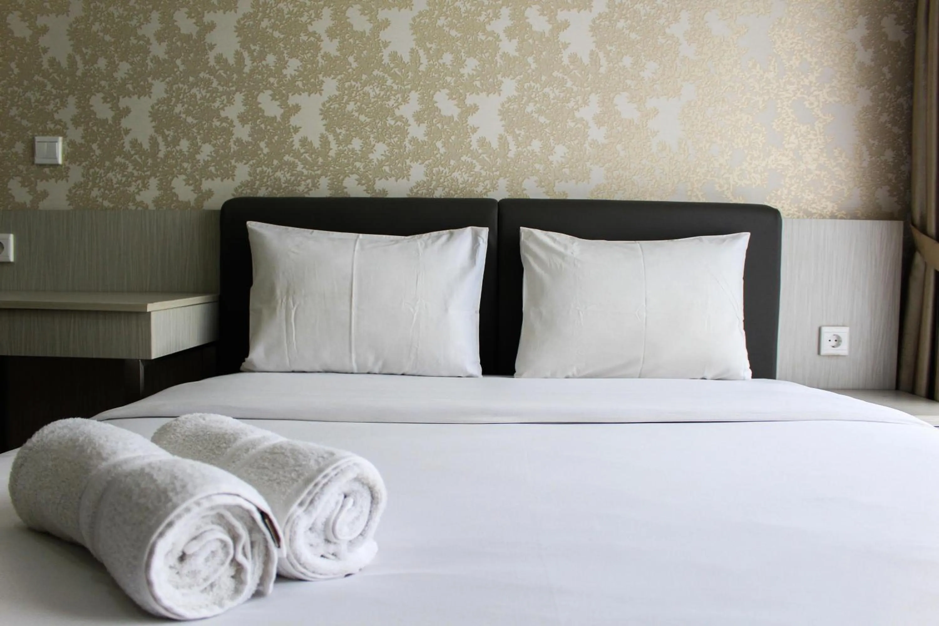 Bed in Minimalist 1BR Apartment at M-Town Signature By Travelio