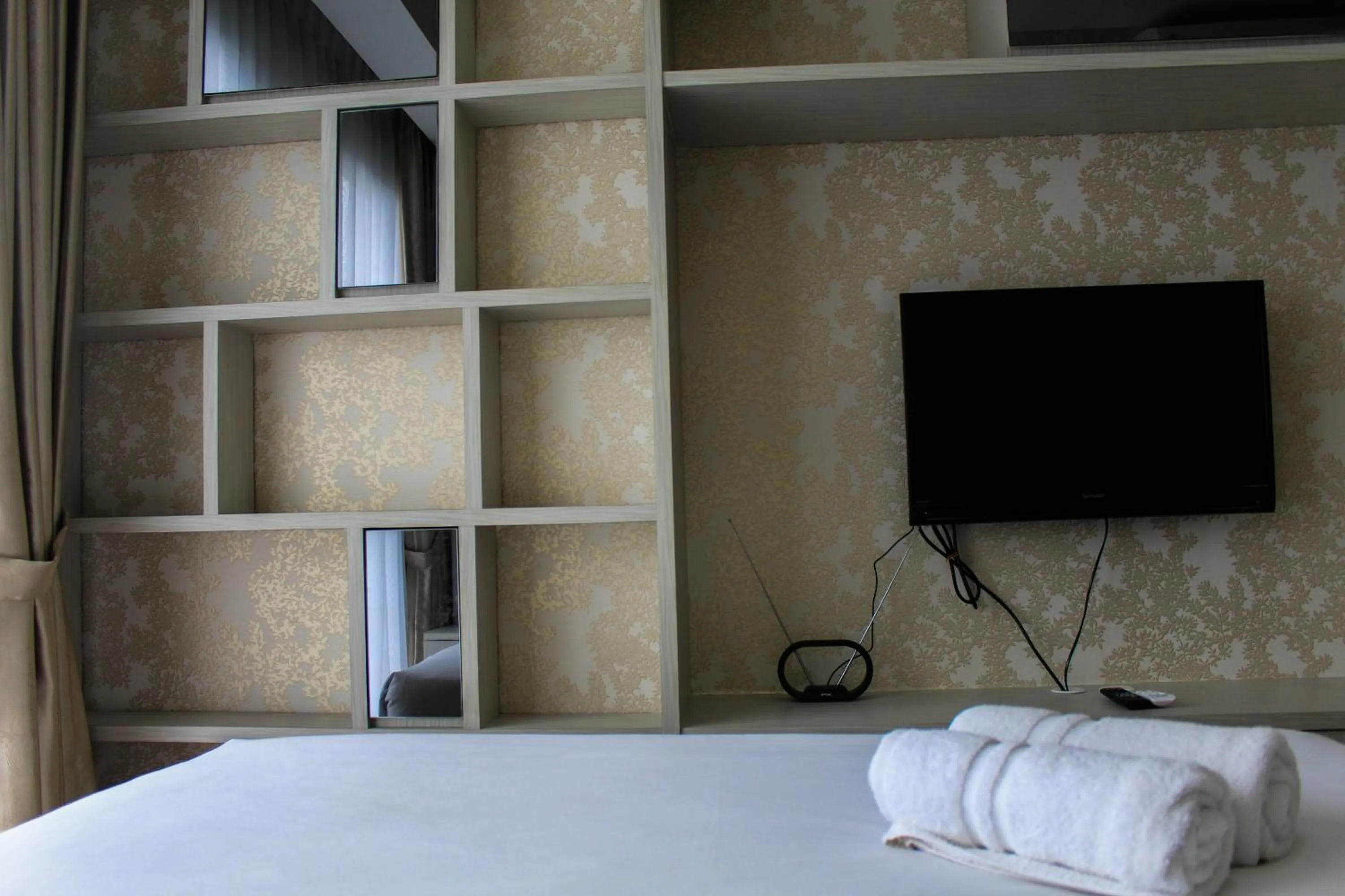 Bed in Minimalist 1BR Apartment at M-Town Signature By Travelio