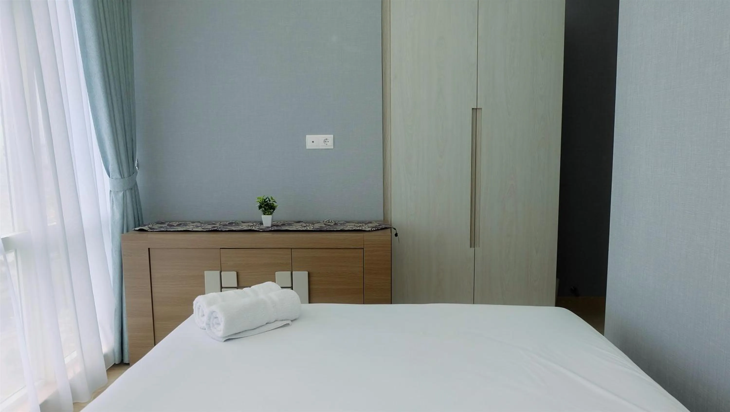 Bed in Classy 2BR Apartment at Menteng Park with City View By Travelio