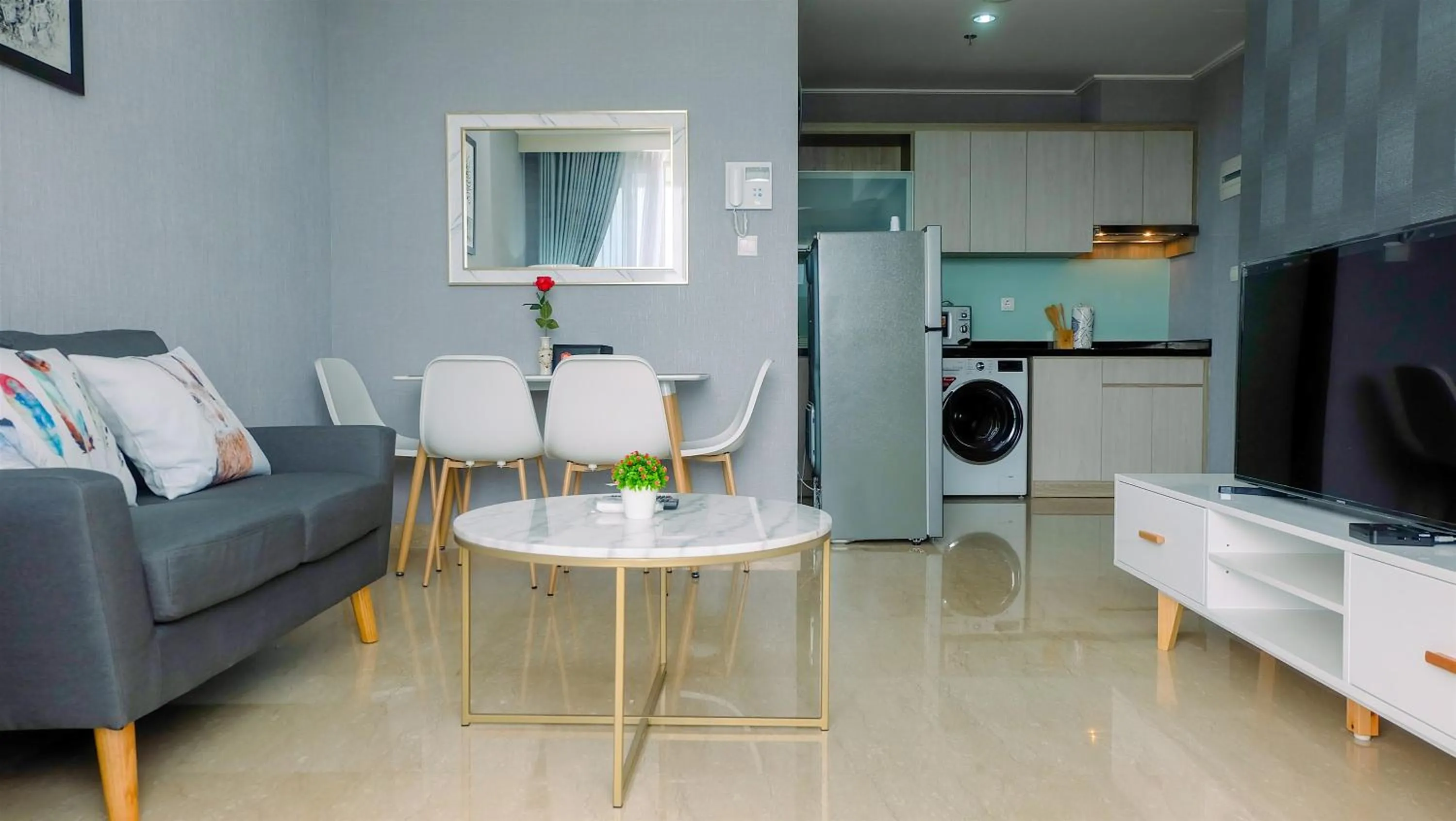 Living room in Classy 2BR Apartment at Menteng Park with City View By Travelio