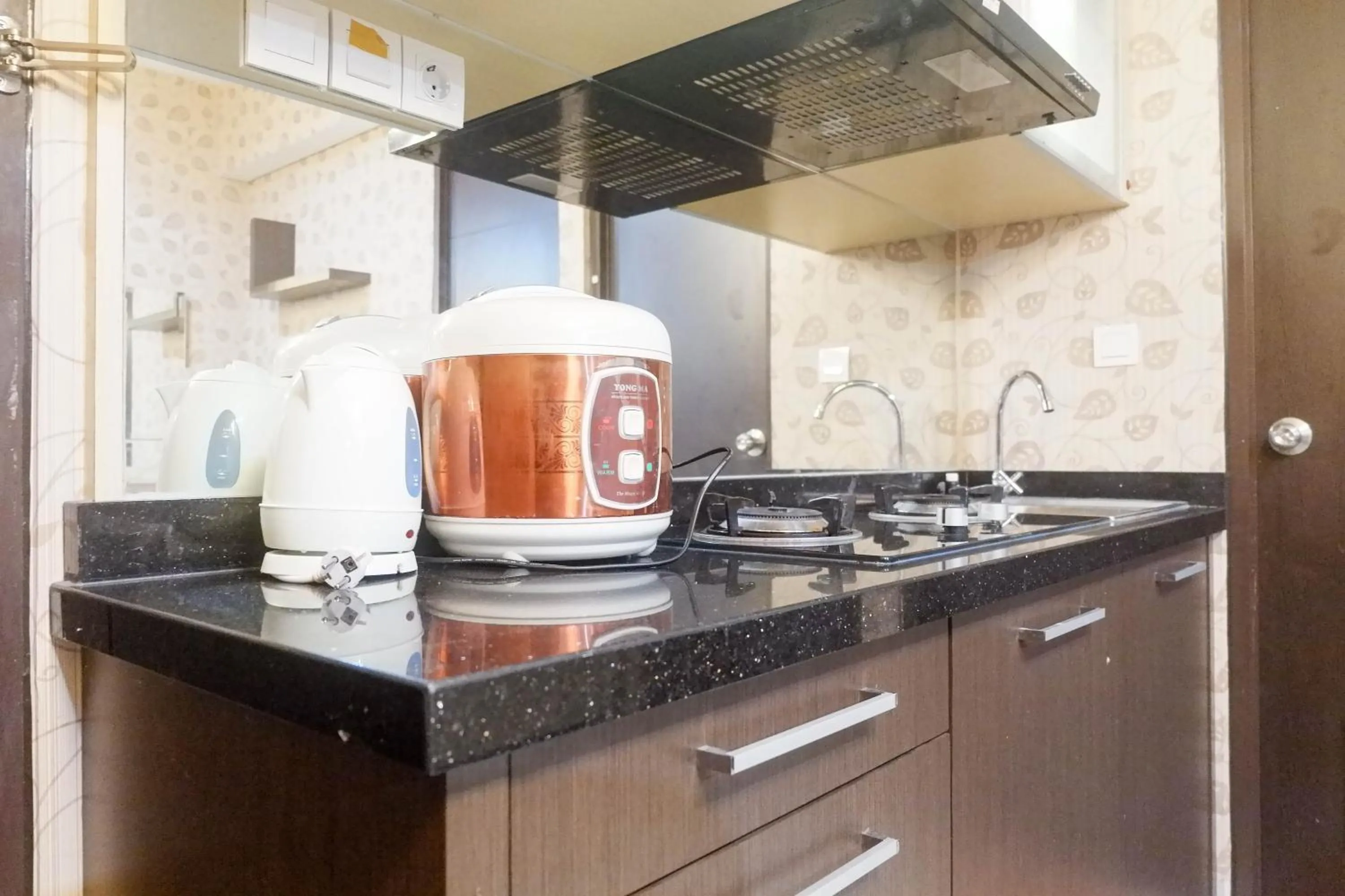 Kitchen or kitchenette in Minimalist 2BR Apartment at Tamansari Papilio By Travelio