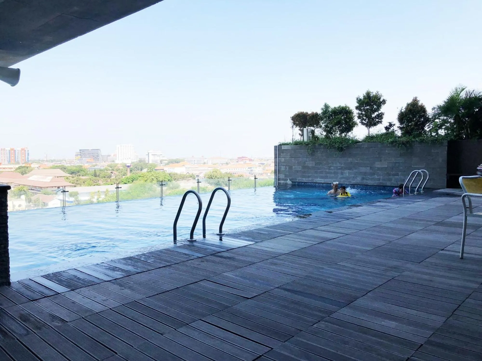 Swimming pool in Minimalist 2BR Apartment at Tamansari Papilio By Travelio