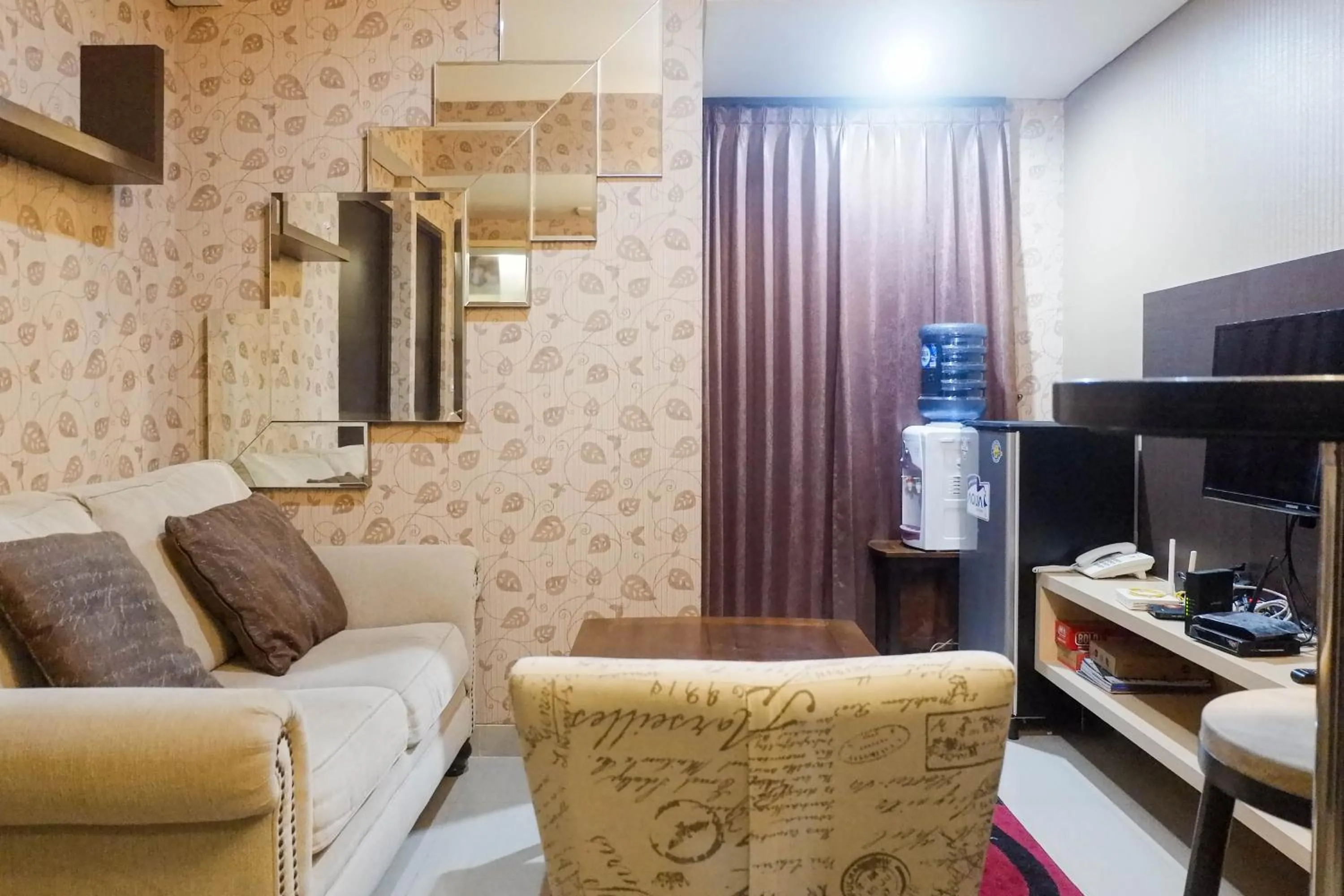 TV and multimedia in Minimalist 2BR Apartment at Tamansari Papilio By Travelio