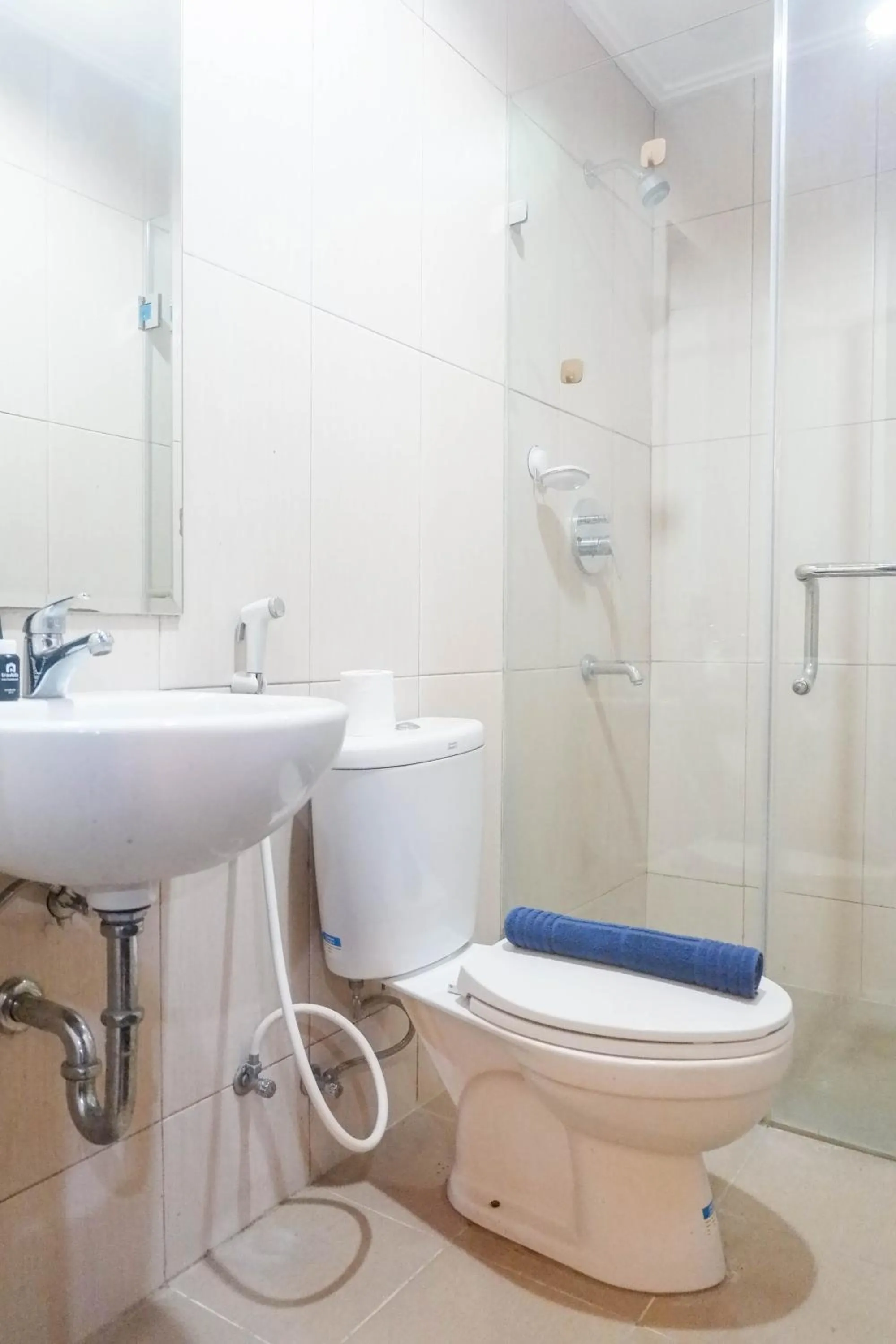 Bathroom in Minimalist 2BR Apartment at Tamansari Papilio By Travelio
