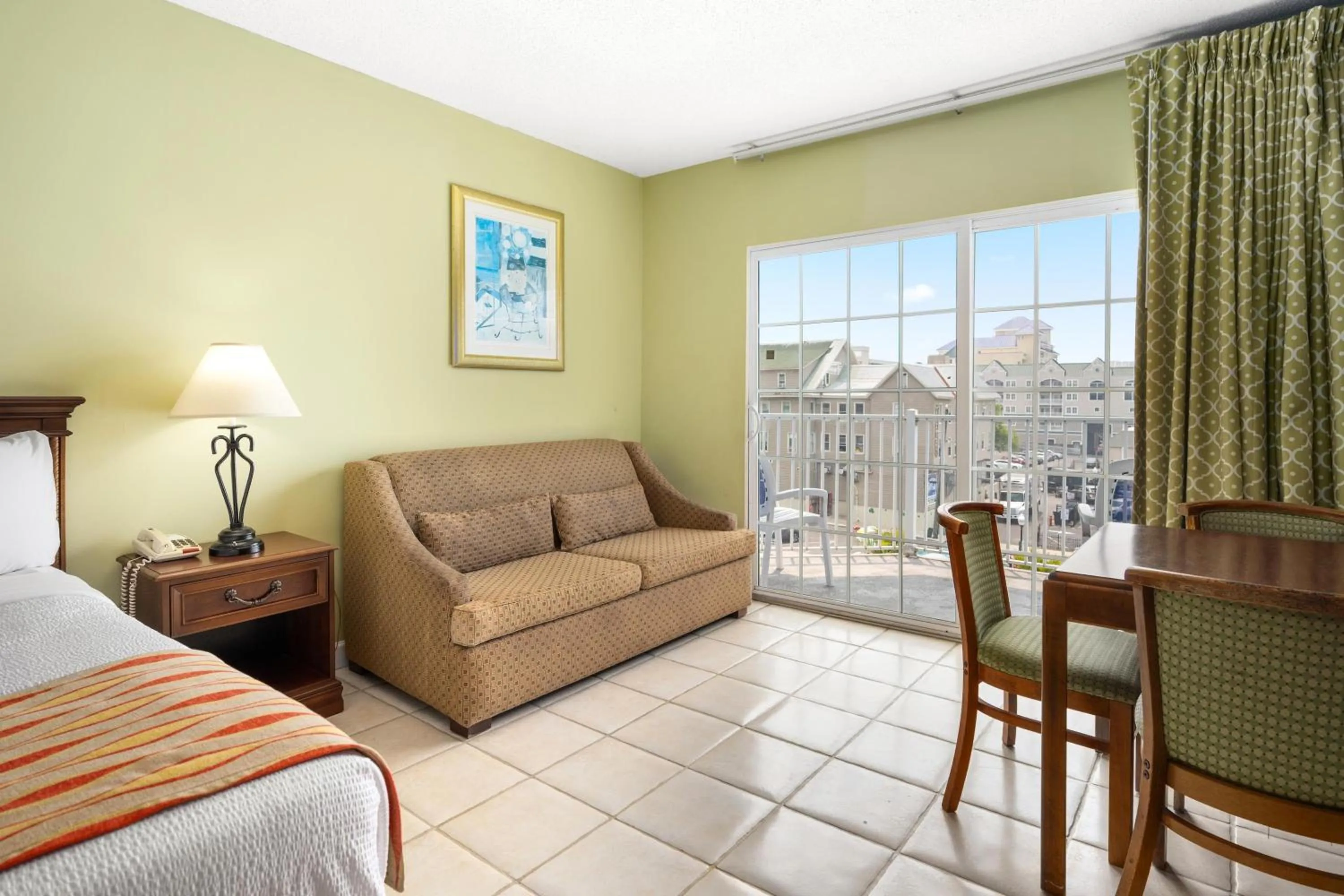 Seating area, Bed in Tidelands Caribbean Boardwalk Hotel and Suites