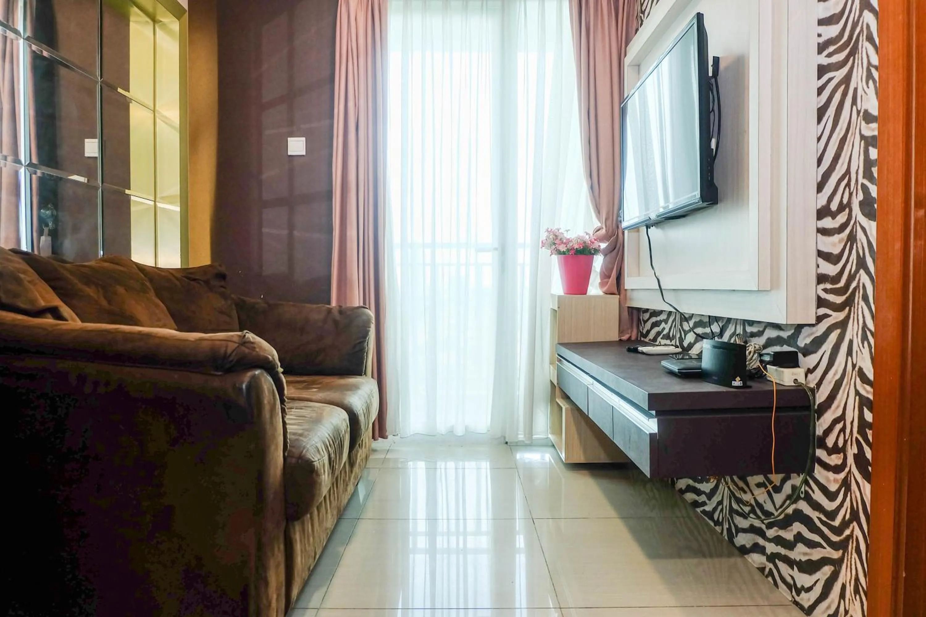 Good Location with Simply Furnished 1BR Apartment Woodland Park Residence By Travelio