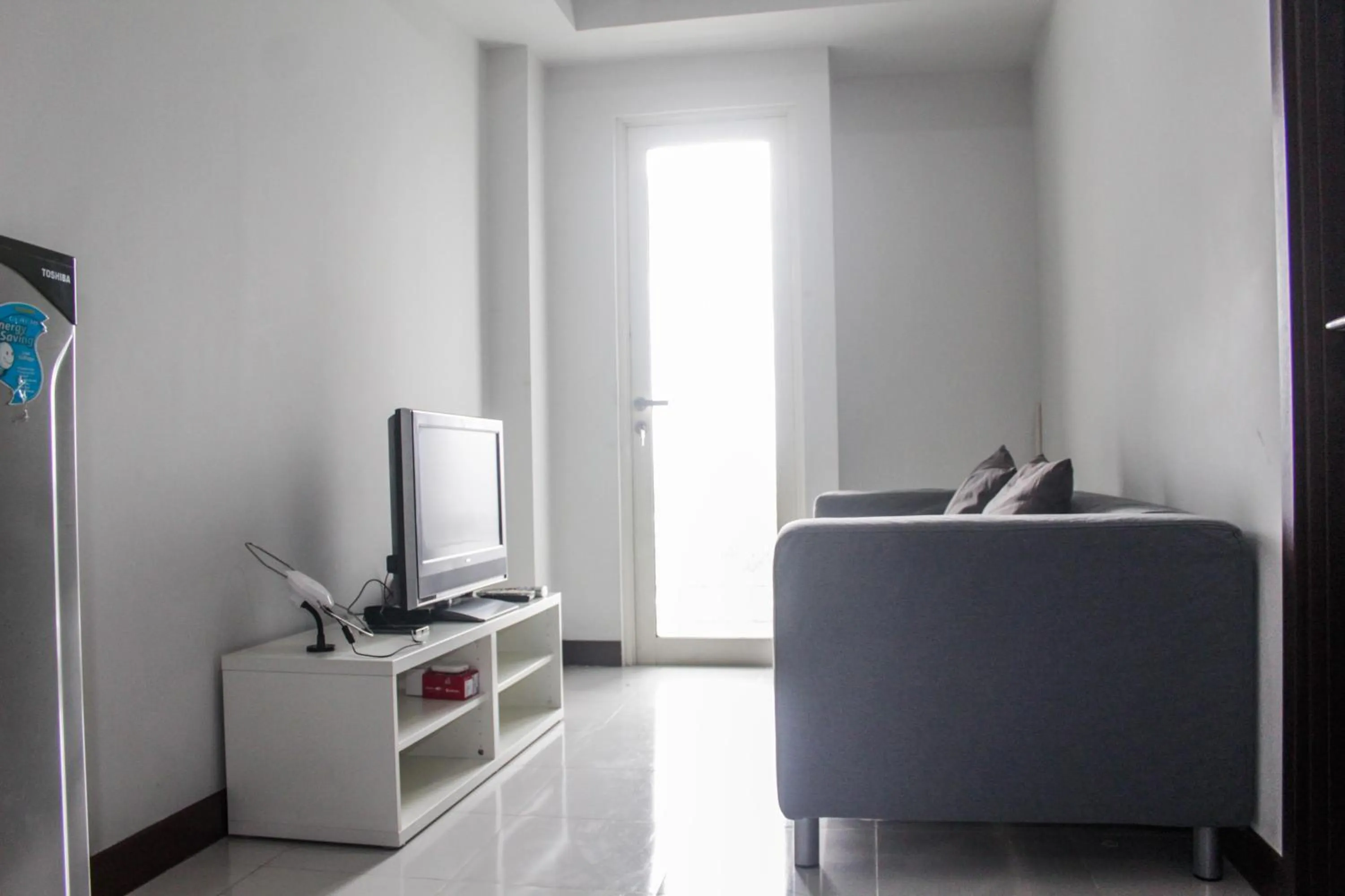 Living room in Minimalist and Comfy 1BR Apartment Scientia Residence By Travelio