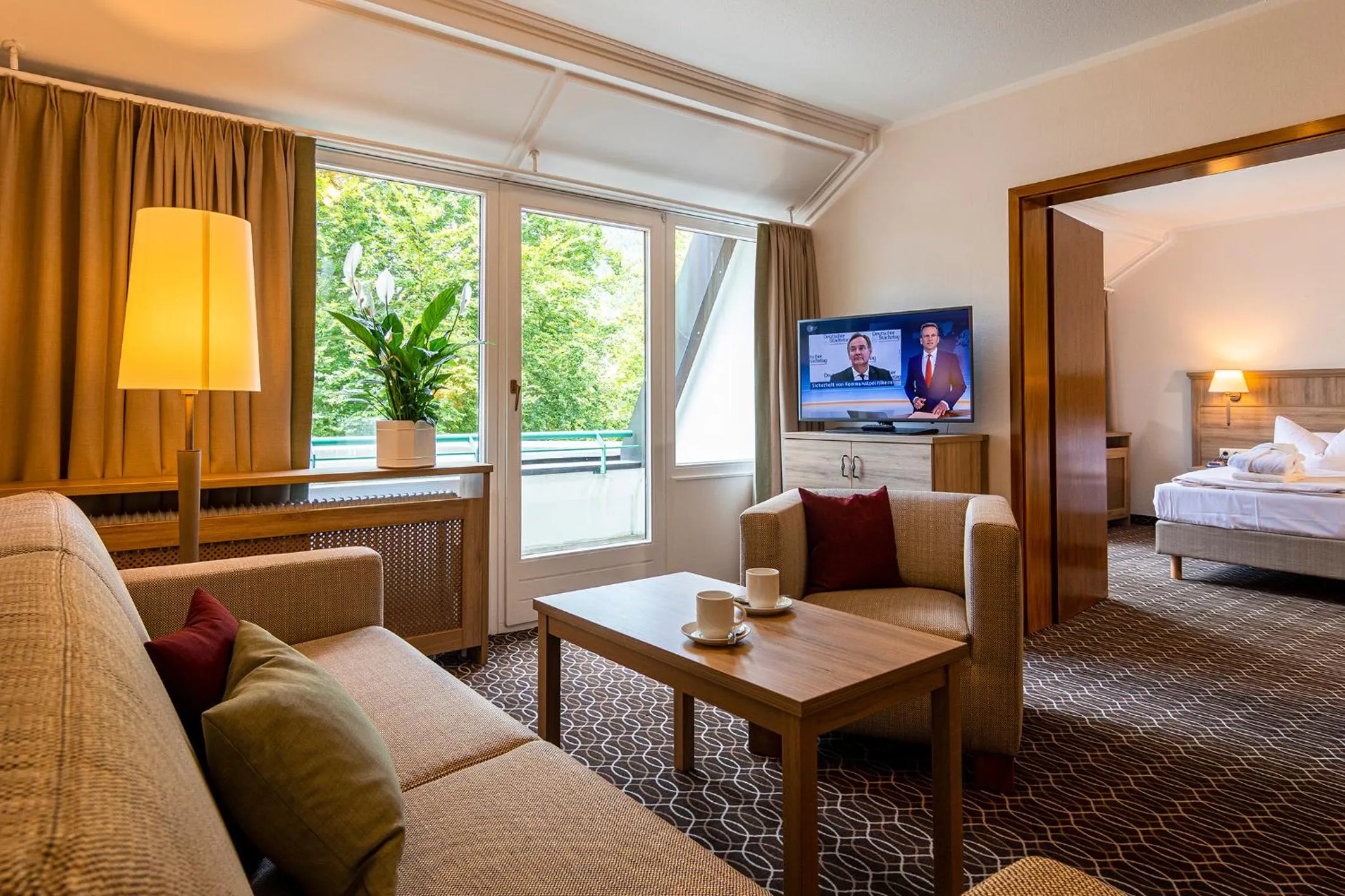 Living room, Bed in AMBER HOTEL Bavaria Superior