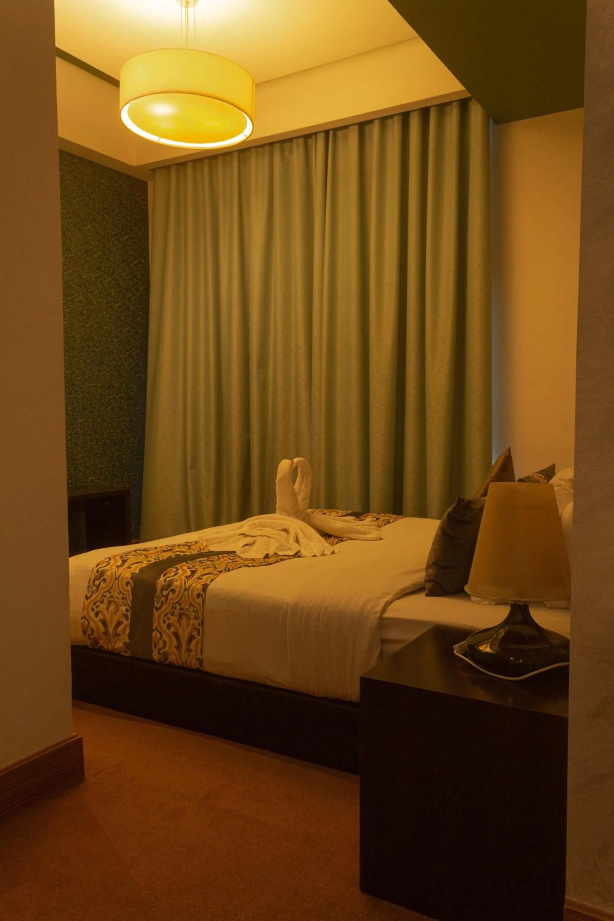 Photo of the whole room, Bed in Blaire Executive Suites