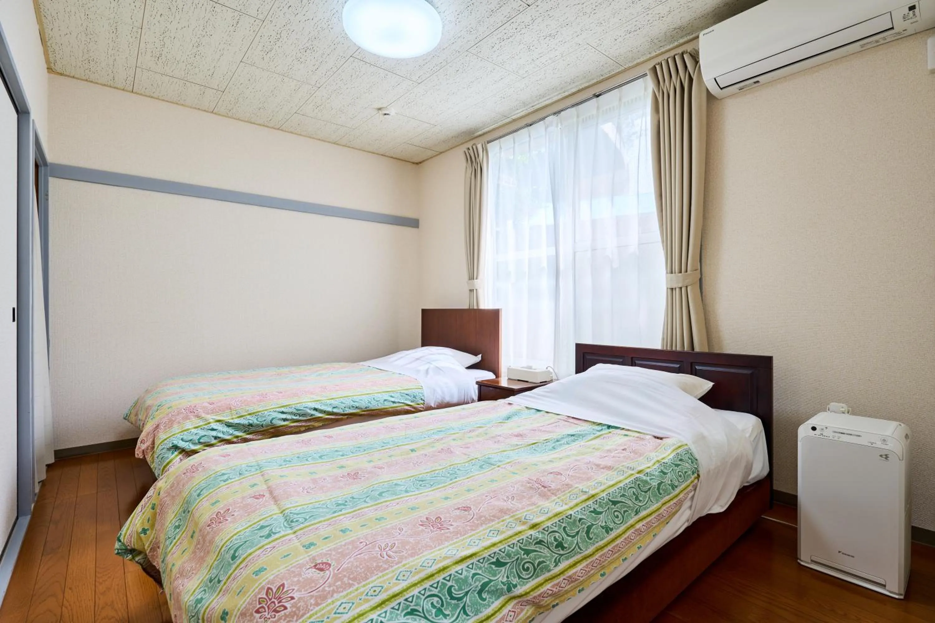 Bed in Enoshima Apartment Hotel