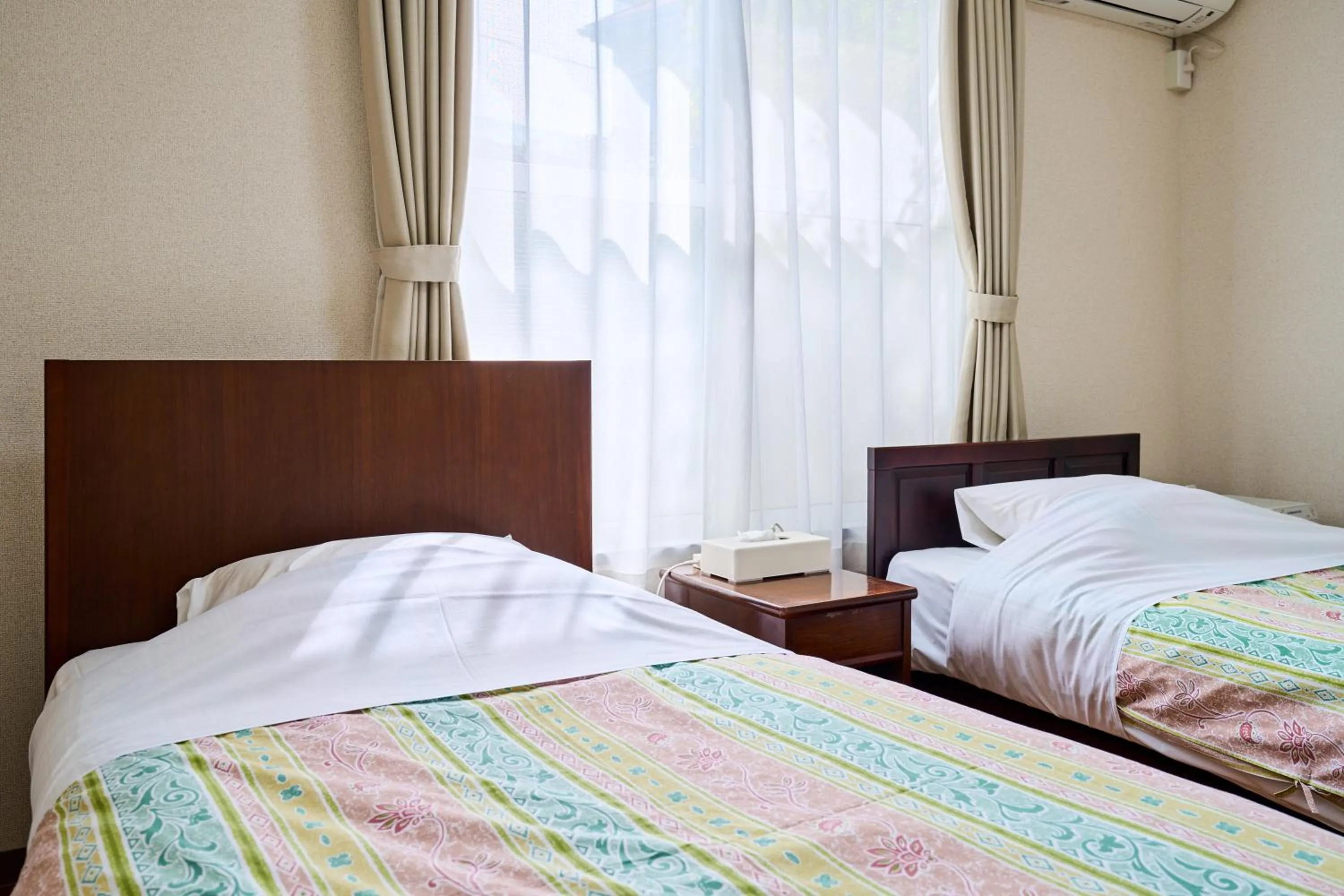Bed in Enoshima Apartment Hotel