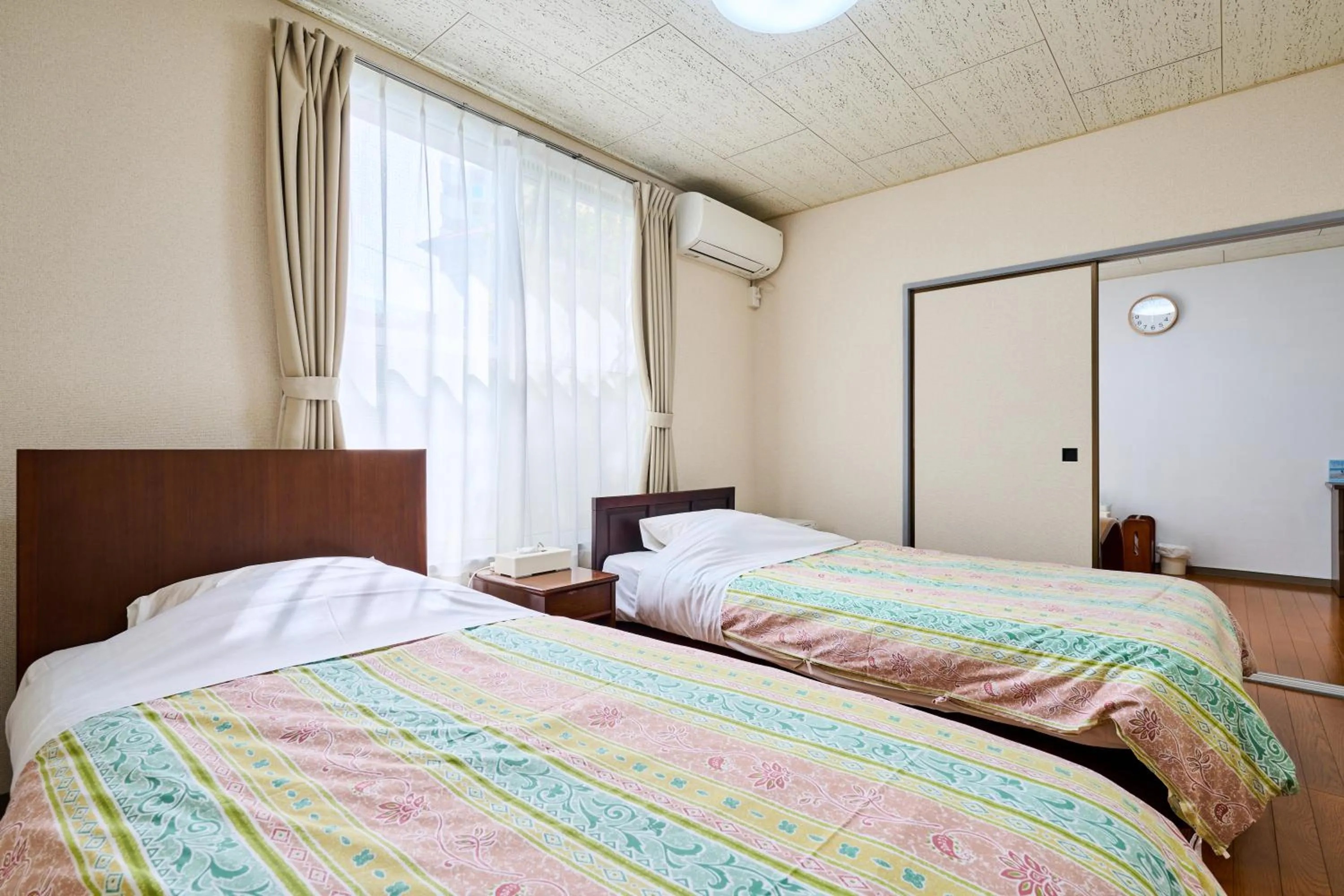 Bed in Enoshima Apartment Hotel