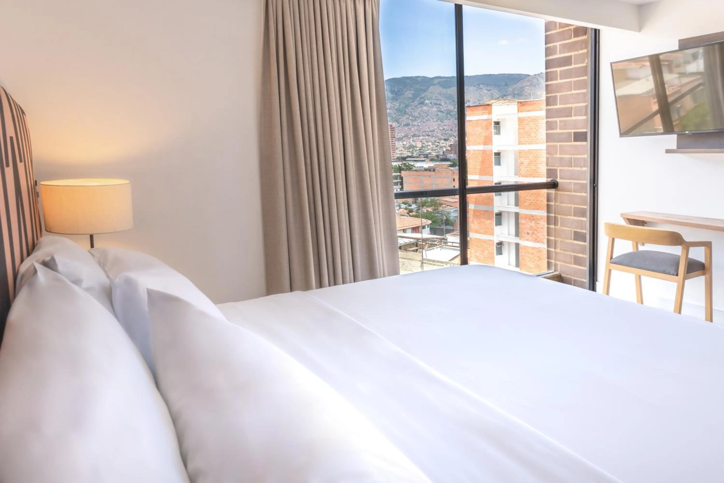 Bed in Origen Local Suites