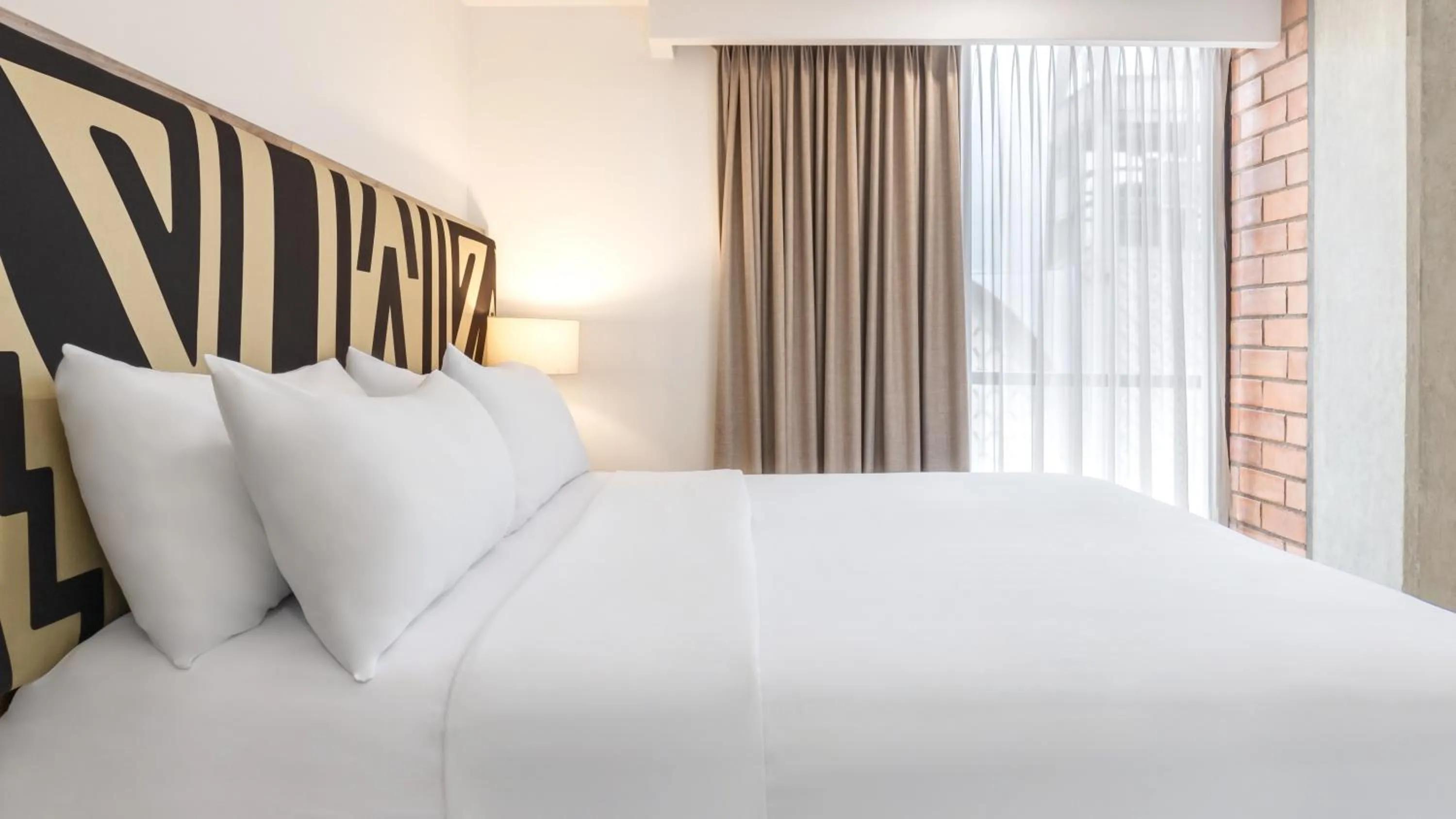 Bed in Origen Local Suites