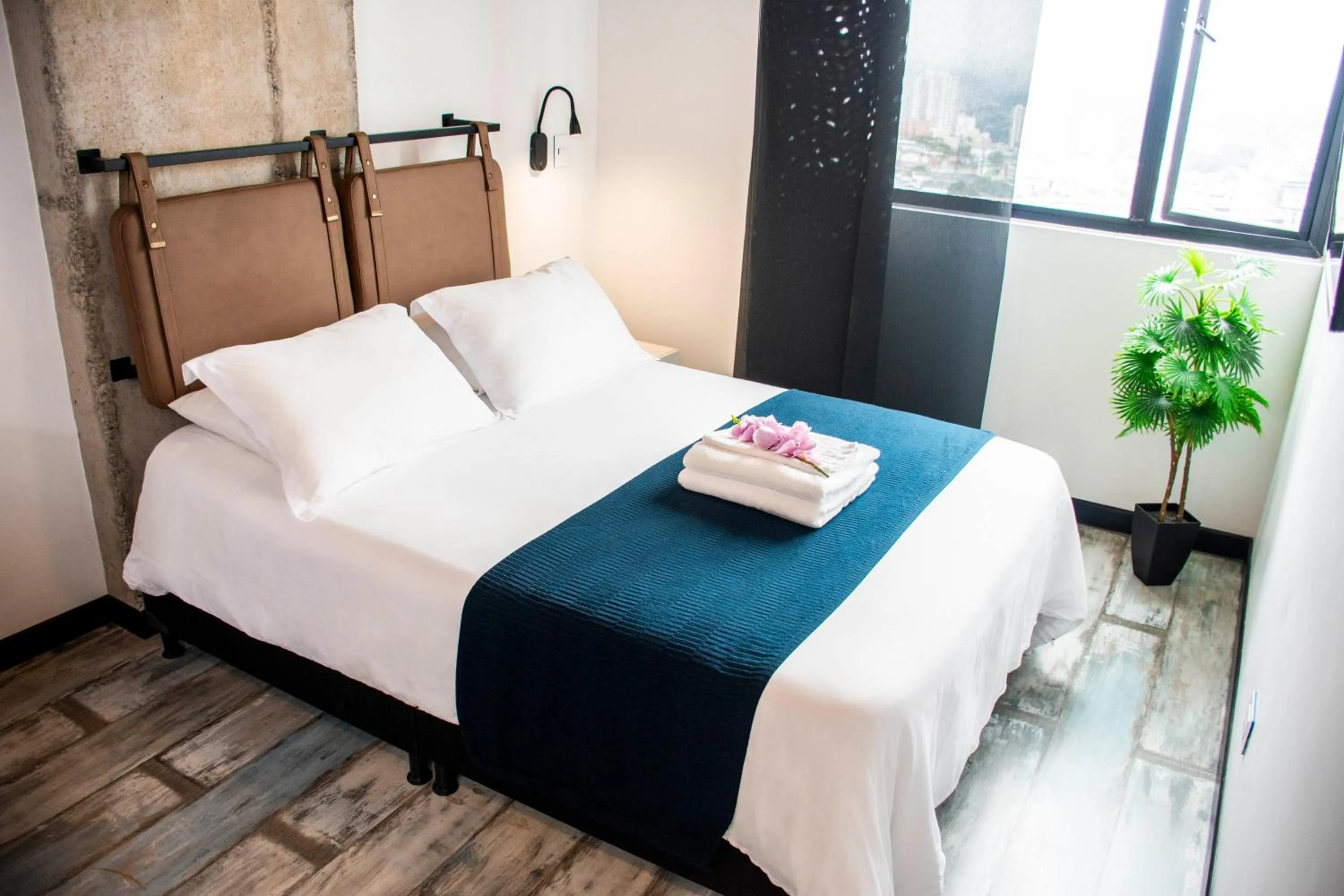 Bed in The Coffee Club Apartahotel