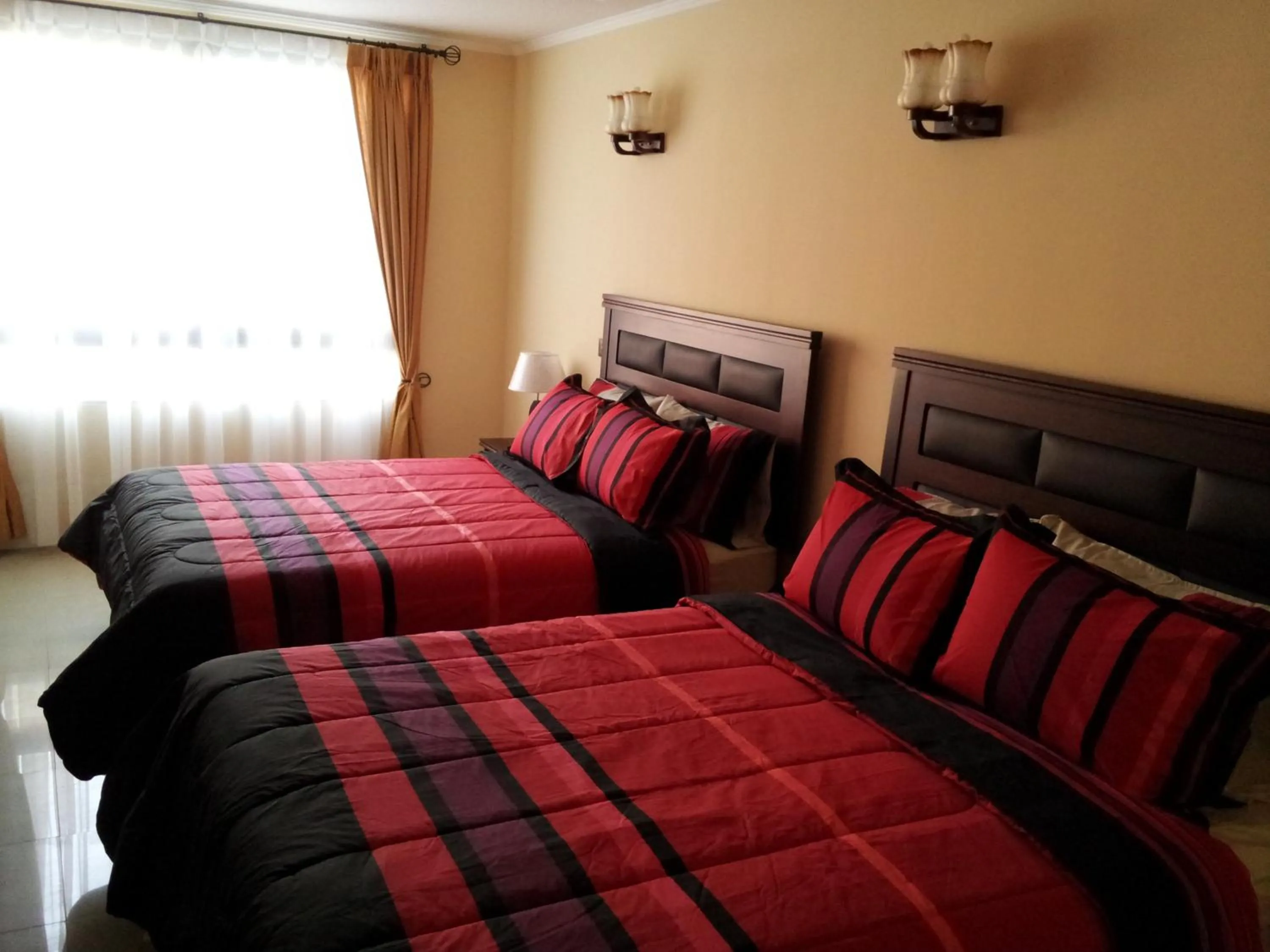 Bed in Hotel Astore Suites
