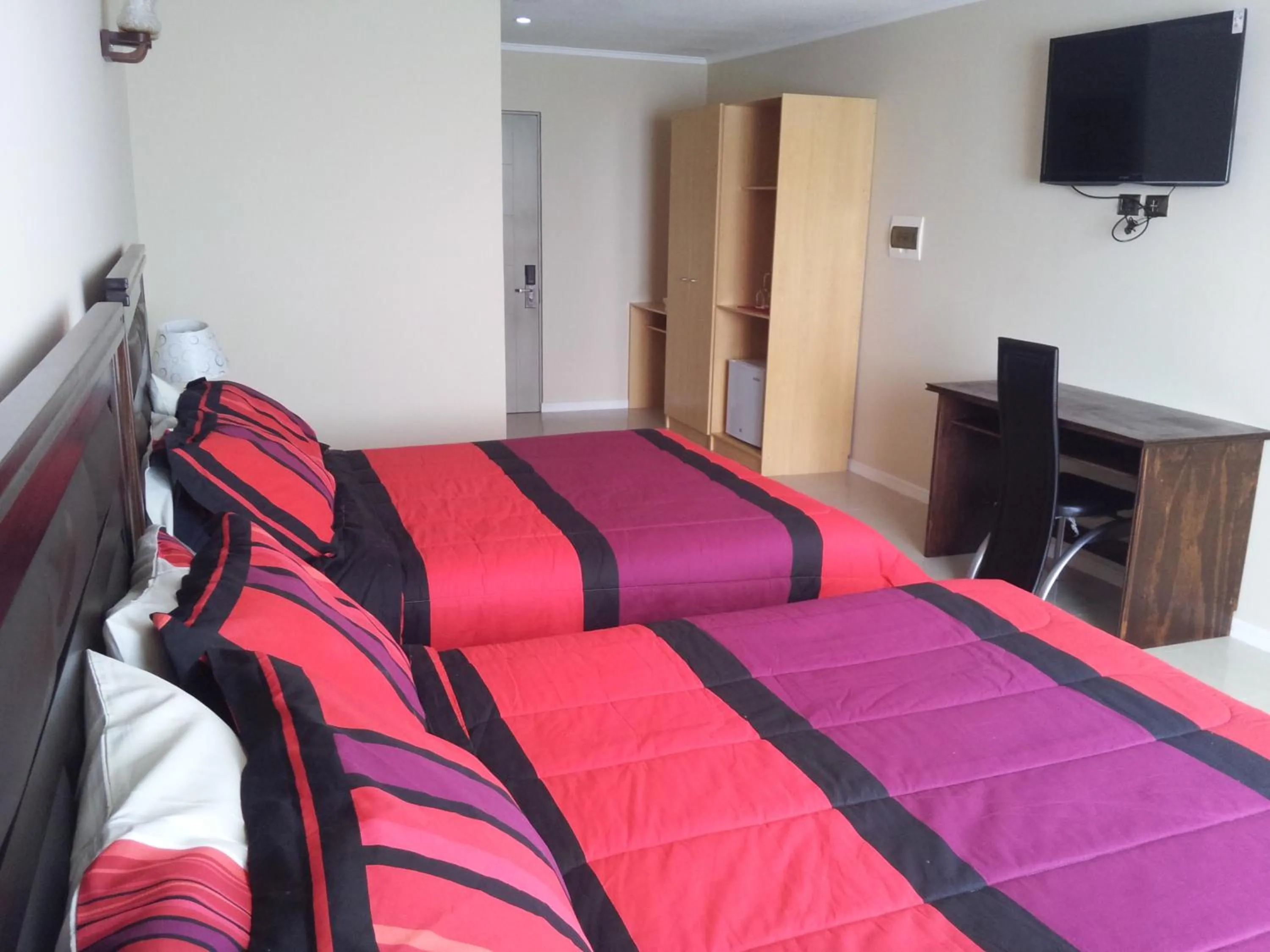 Bed in Hotel Astore Suites
