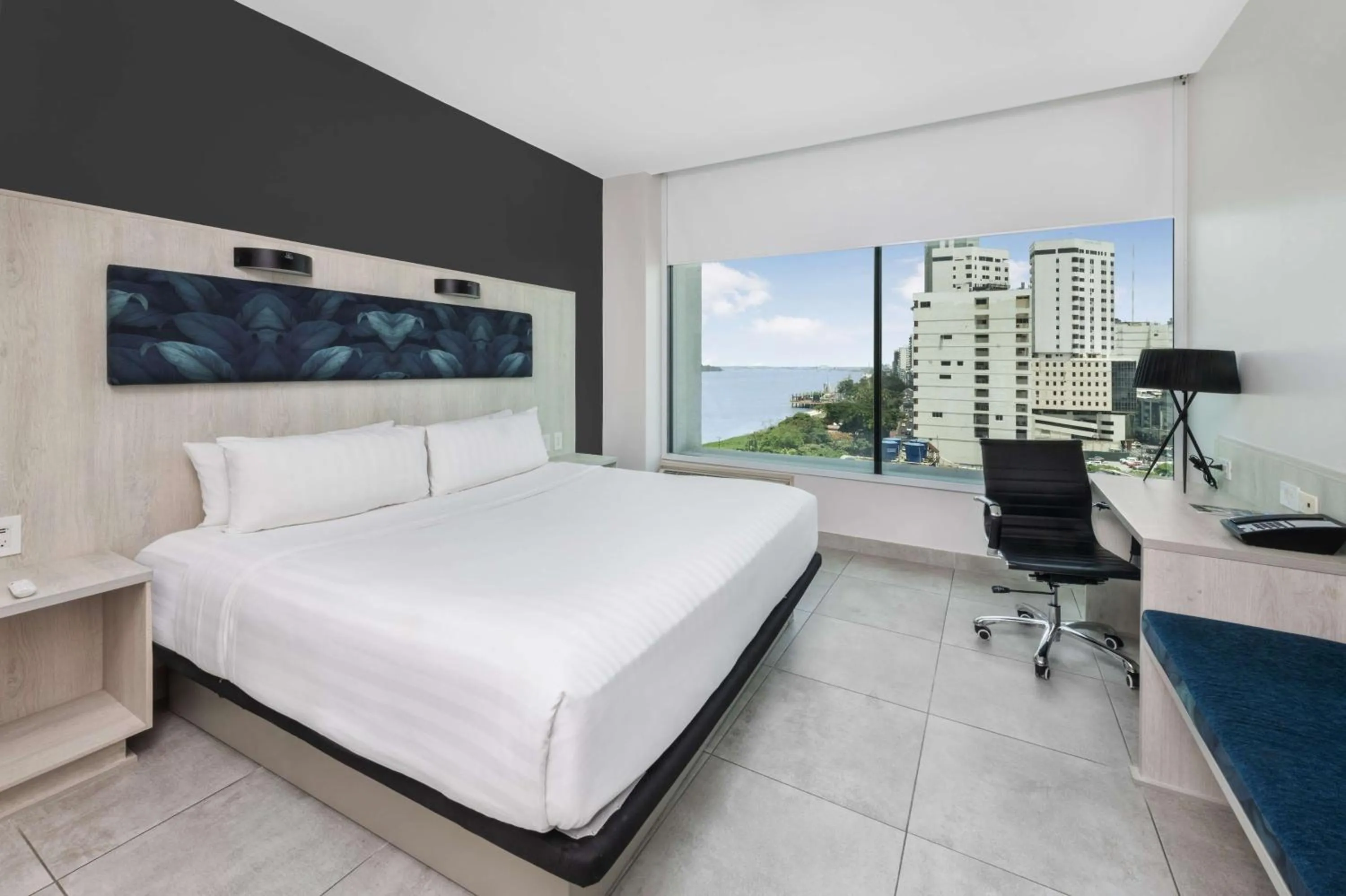 Bed in River Garden Hotel + Suites