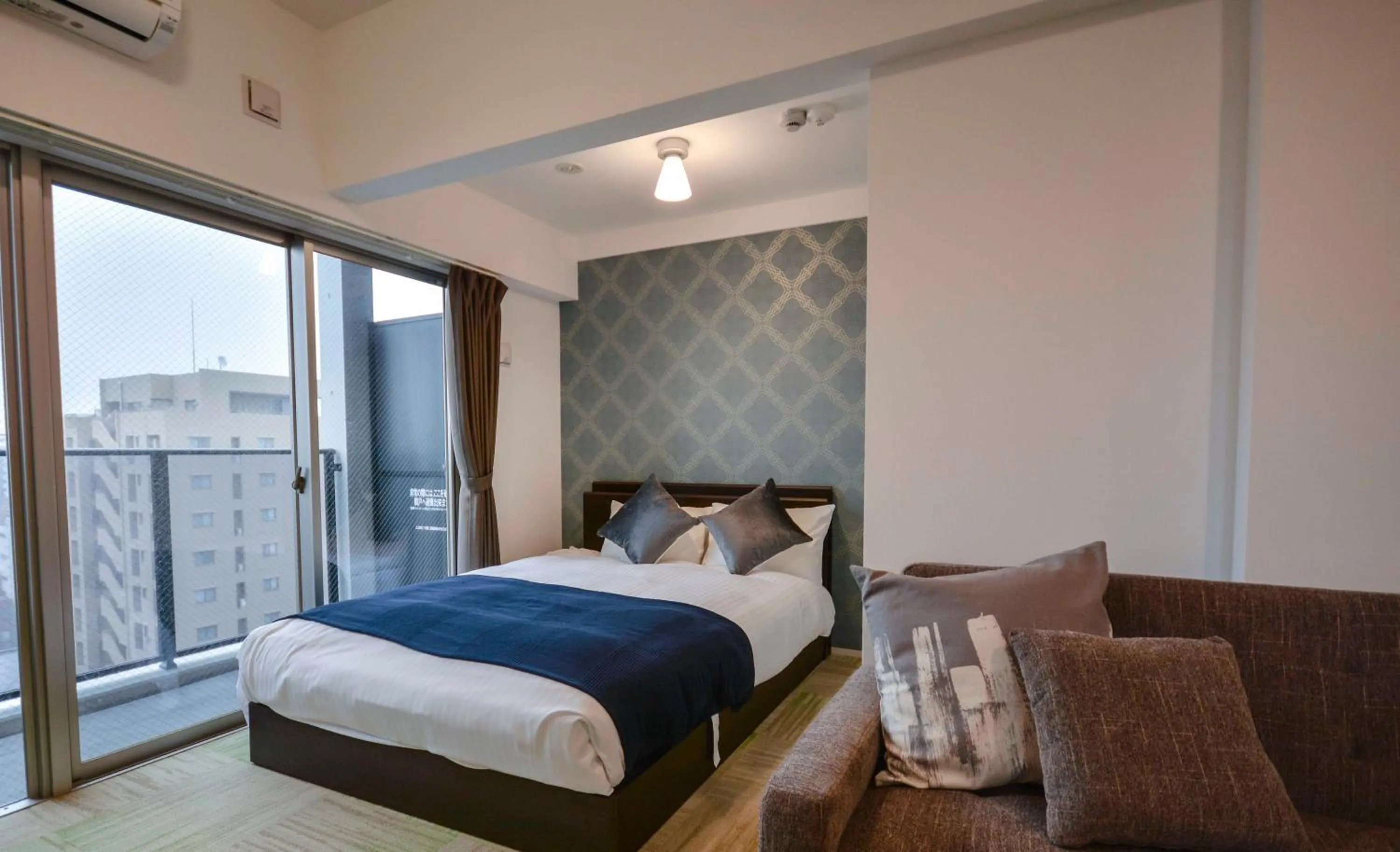 Bed in The Grand Residence Hotel Tenjin