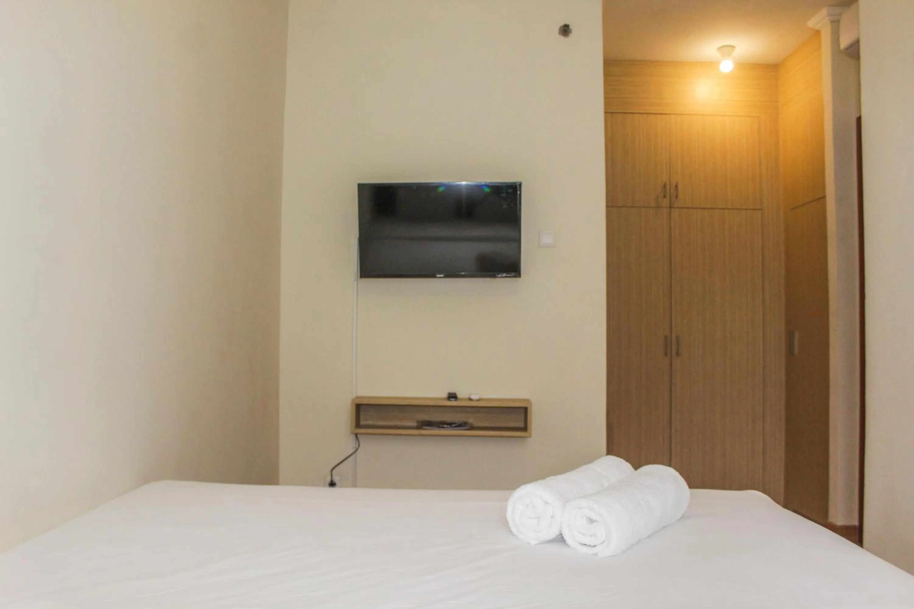 Bed in Homey 2BR Apartment at Grand Palace Kemayoran By Travelio