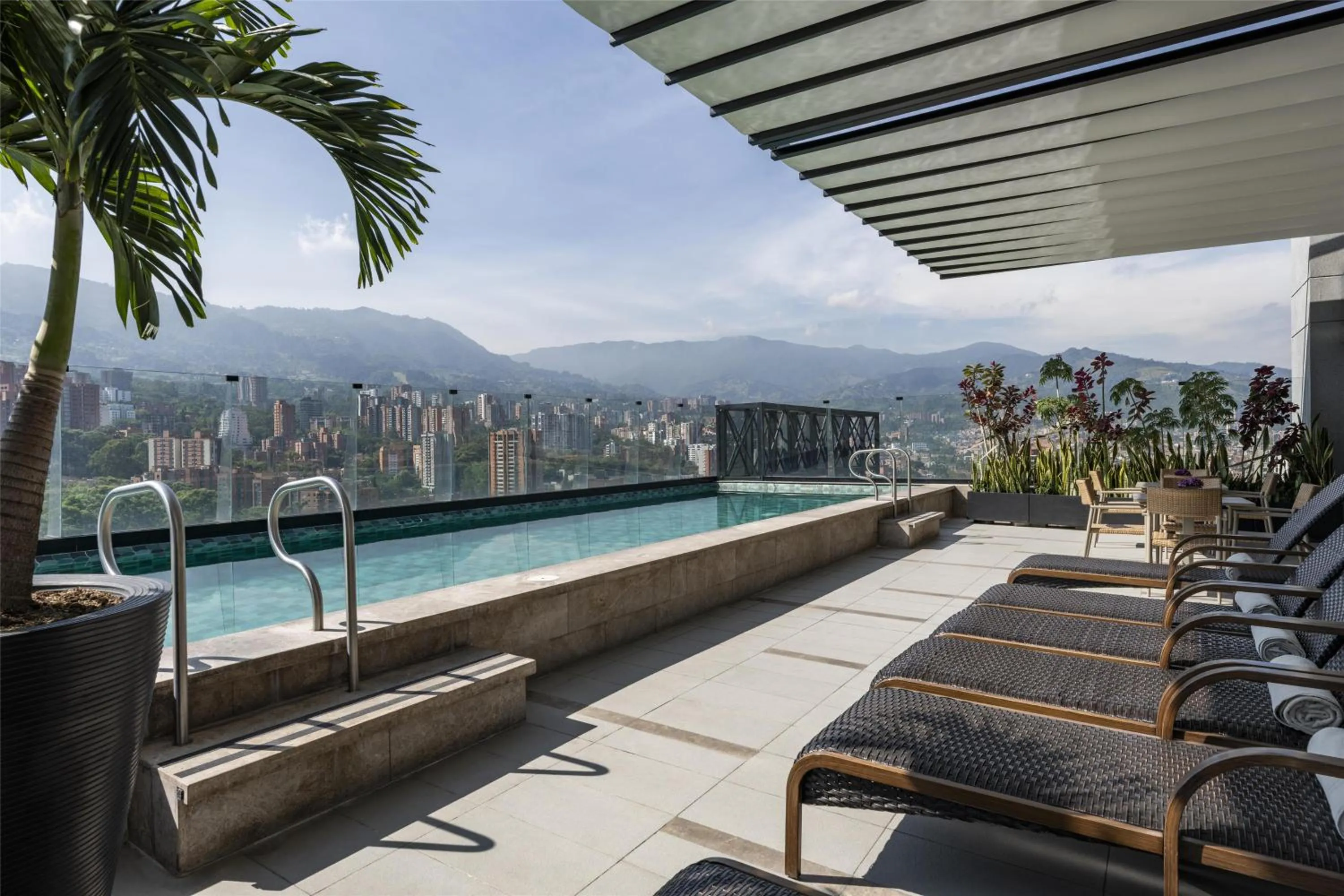 Pool view in York Medellin, Curio Collection by Hilton