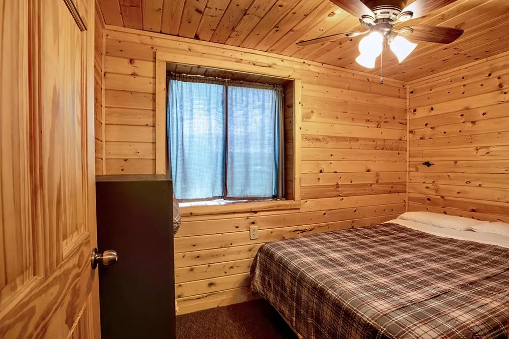 Bed in Big River Escape Riverside Cabins