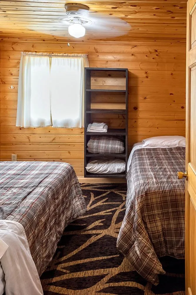 Bed in Big River Escape Riverside Cabins