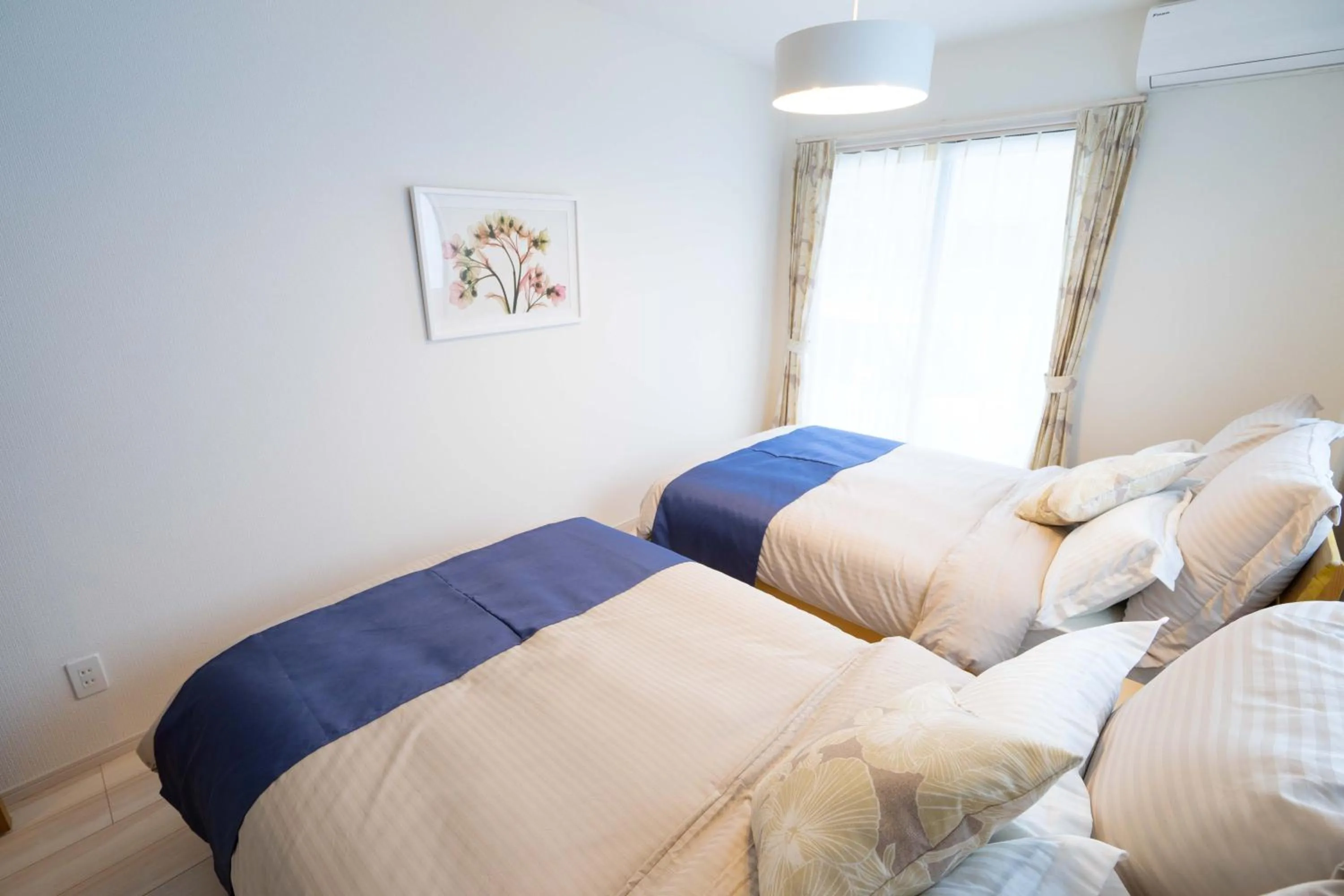 Photo of the whole room, Bed in OKINAWA BEACH HOUSE Golden Drop S