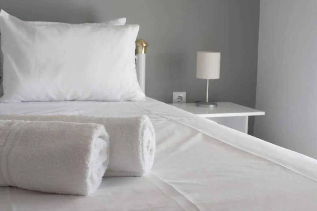 Bed in Kolonos, a renovated apartment