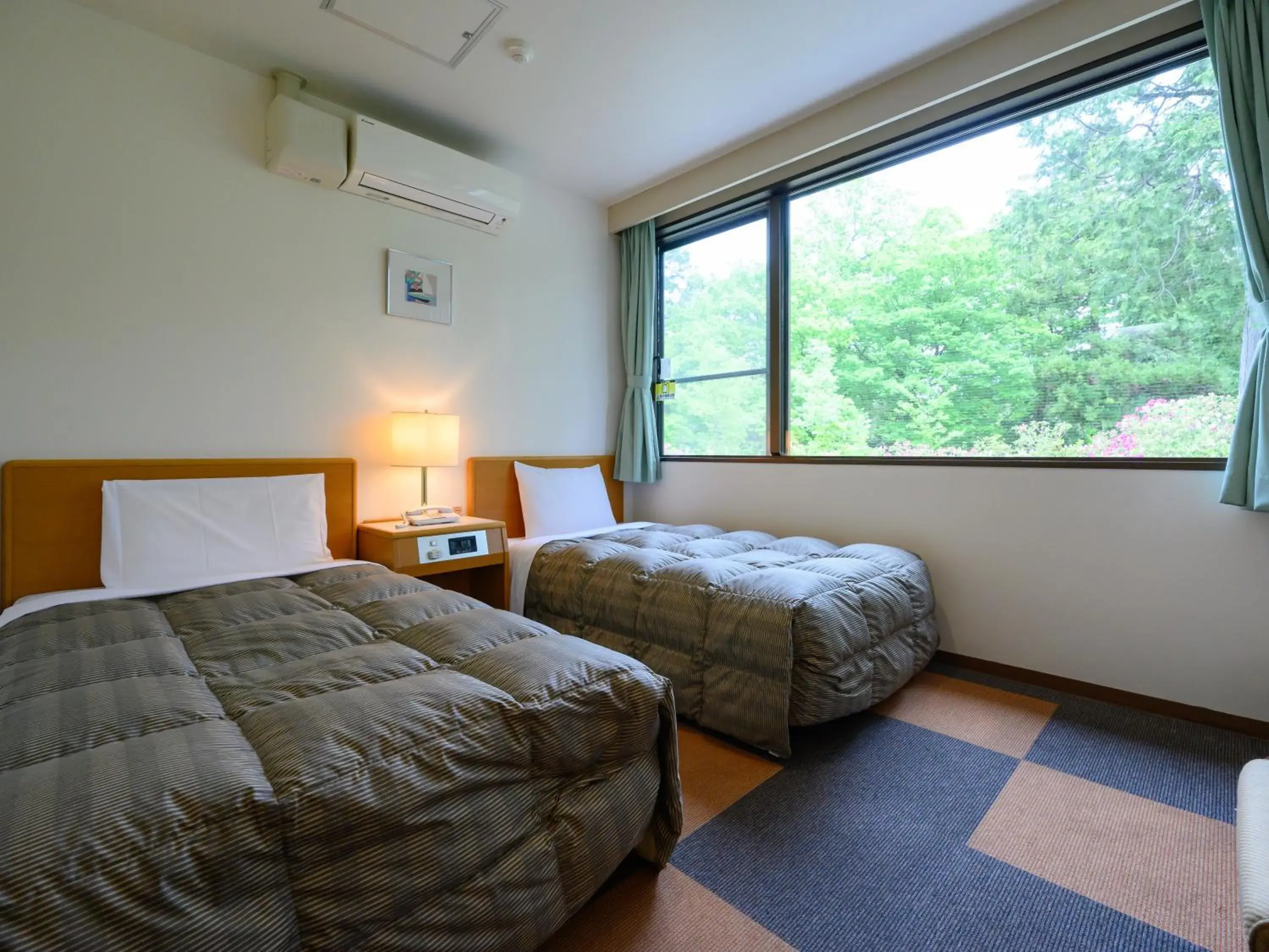 Twin Room with Private Bathroom in Rest Inn Taga Twin Room with Private Bathroom in Rest Inn Taga