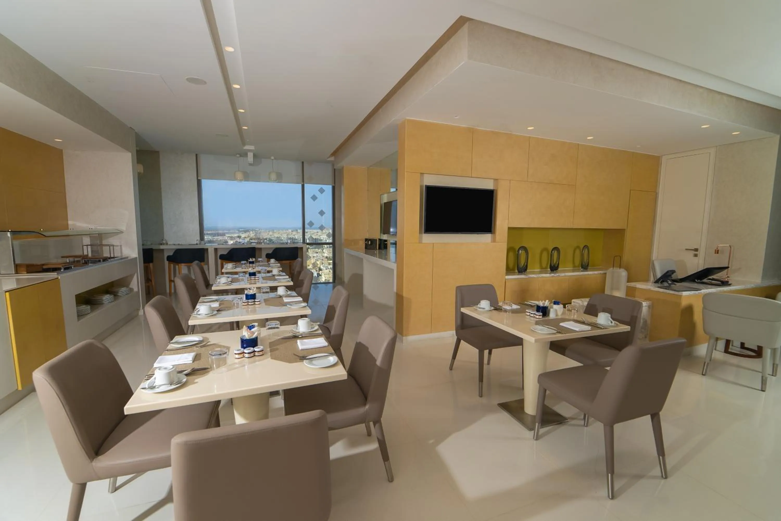 Communal lounge/ TV room in Dana Rayhaan by Rotana
