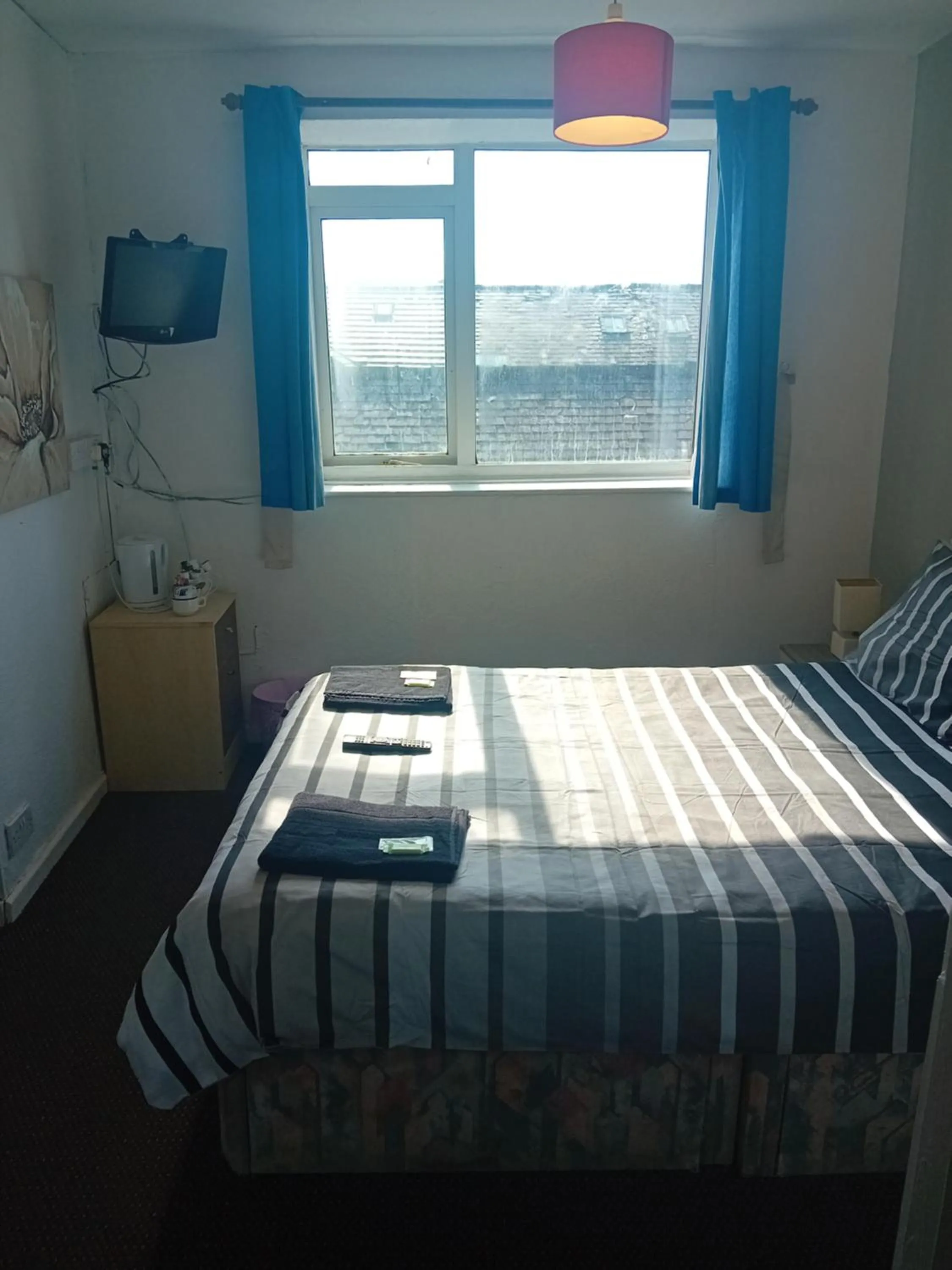 Bed in MyRoomz New Discovery Hotel