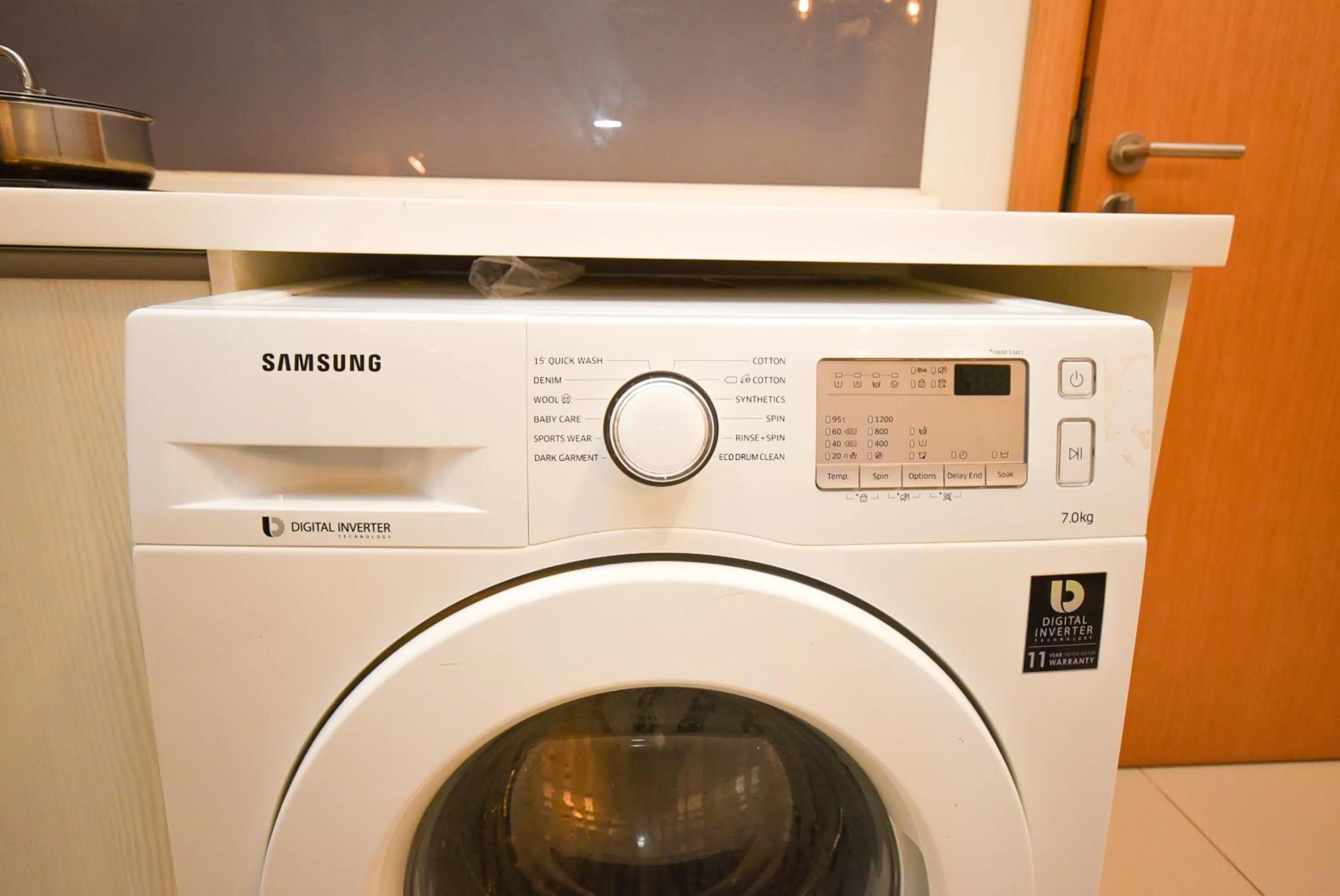 washing machine in Suasana Residence by Nest Home