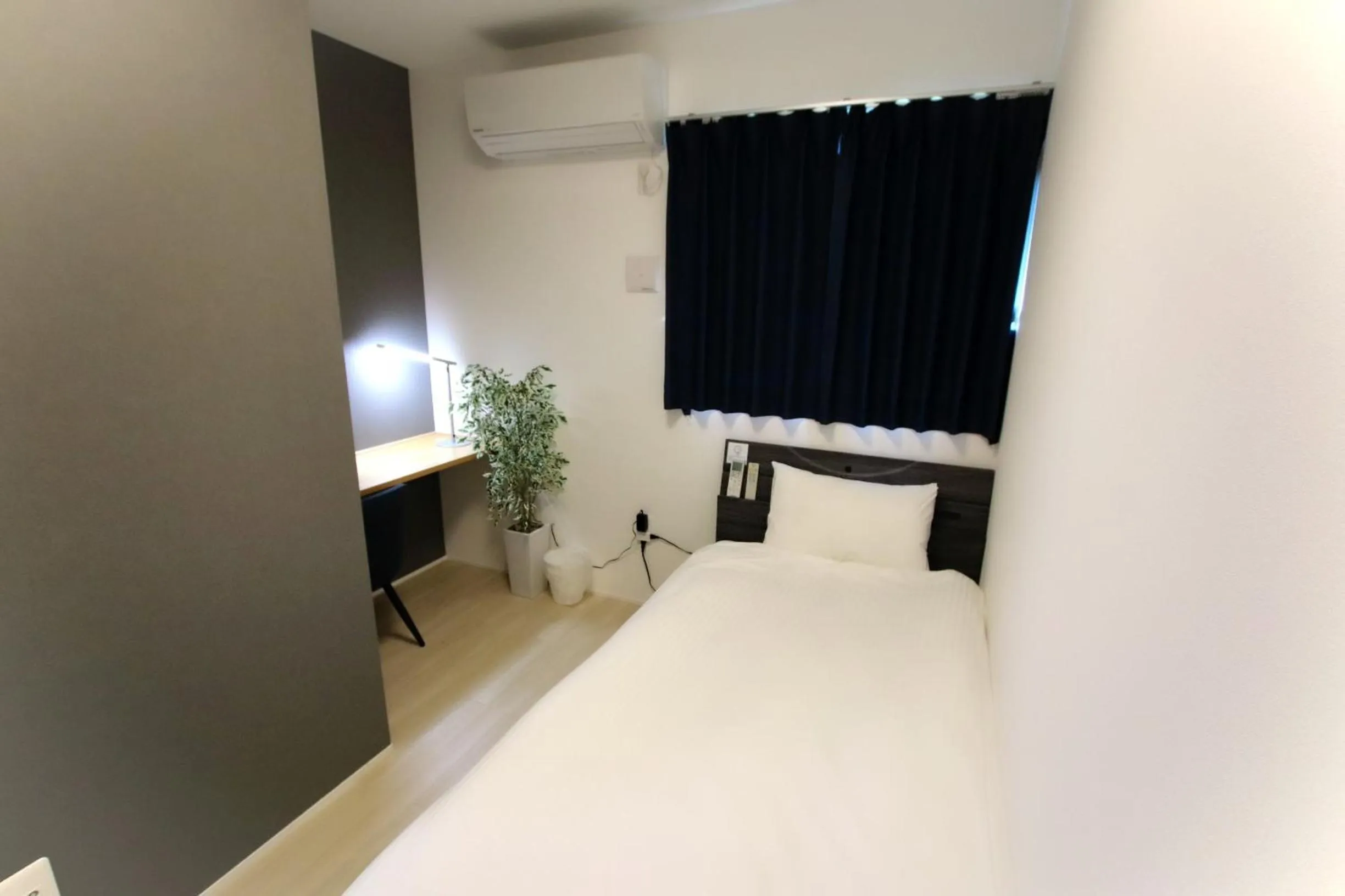 Bed in Hotel Southern Suite Kugai