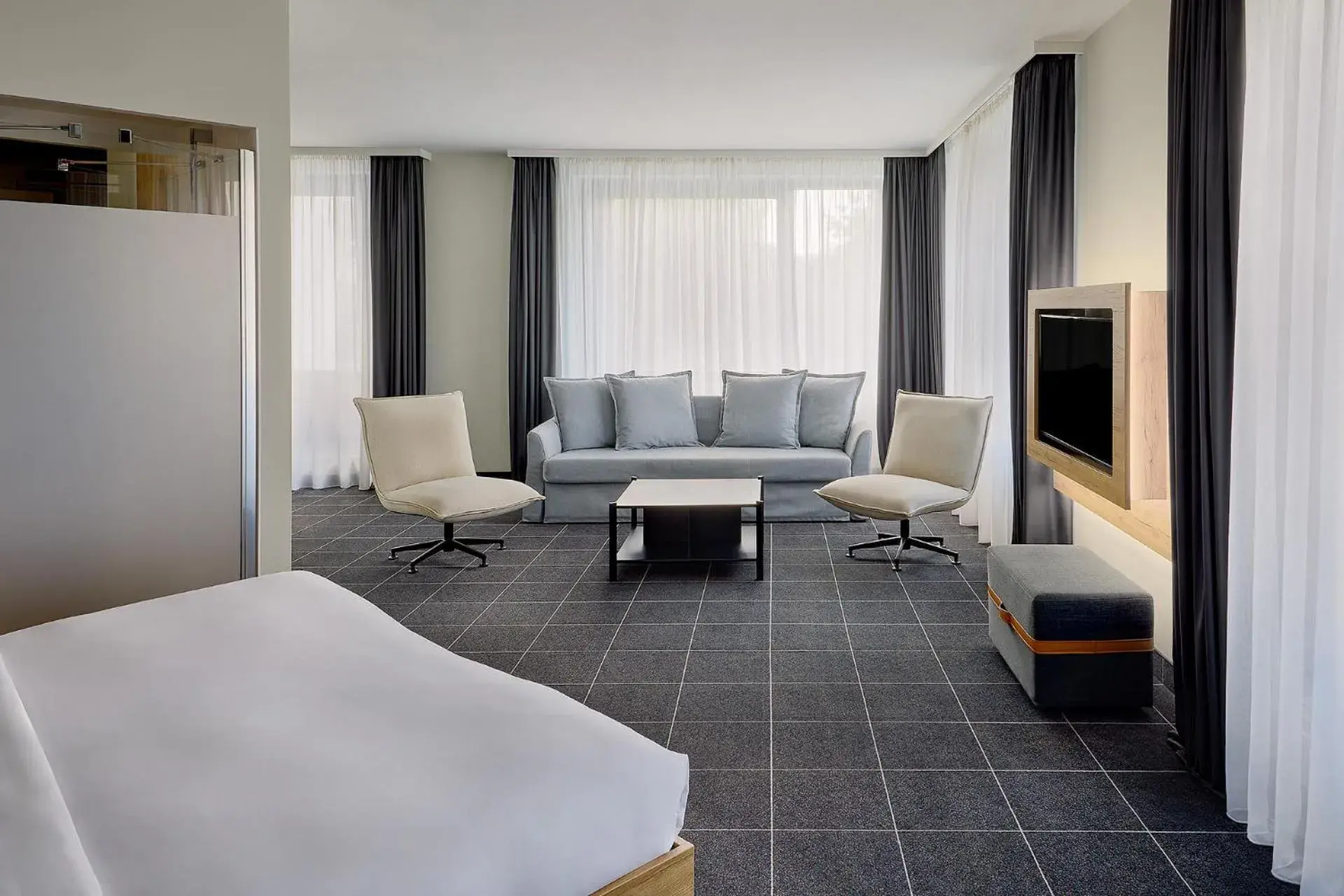 Living room, Bed in Four Points Flex by Sheraton Ratingen Düsseldorf Airport Living room, Bed in Four Points Flex by Sheraton Ratingen Düsseldorf Airport