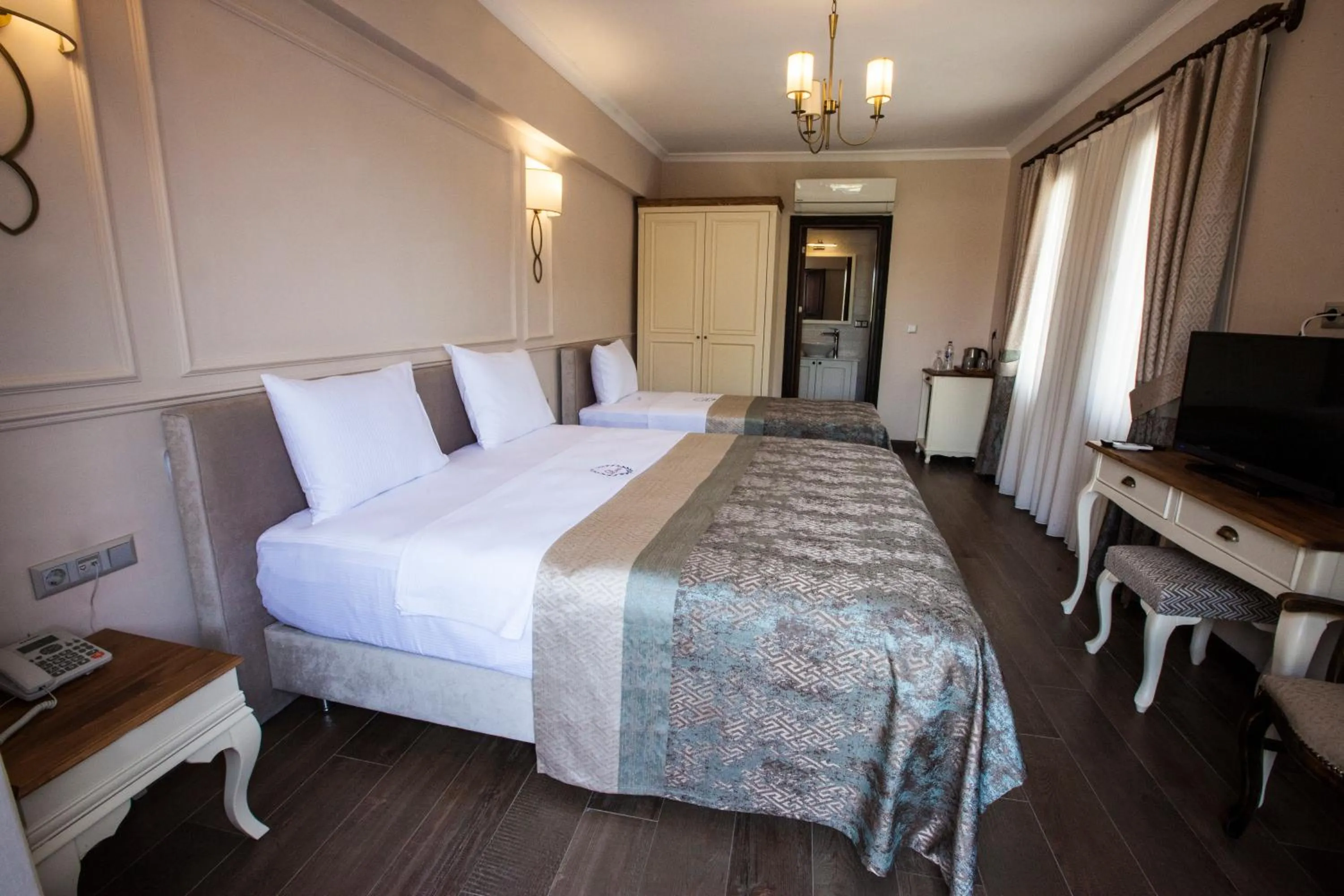 Bed in Livia Garden Hotel