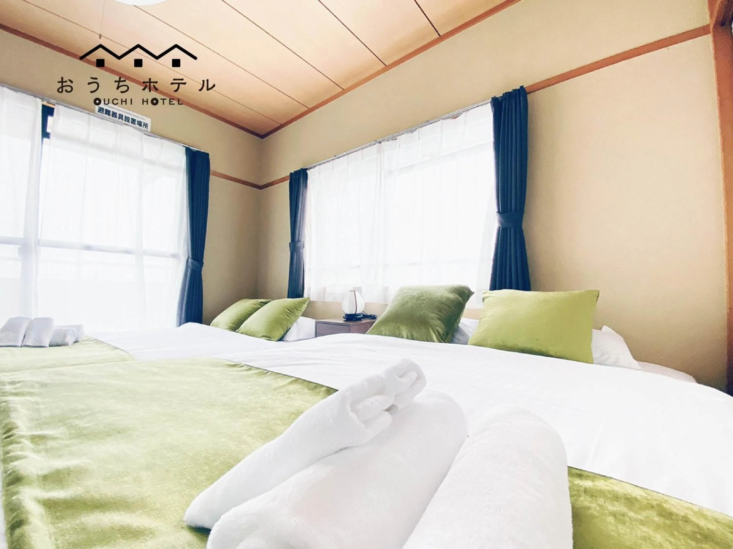 Bed in OUCHI HOTEL Itsukaichi