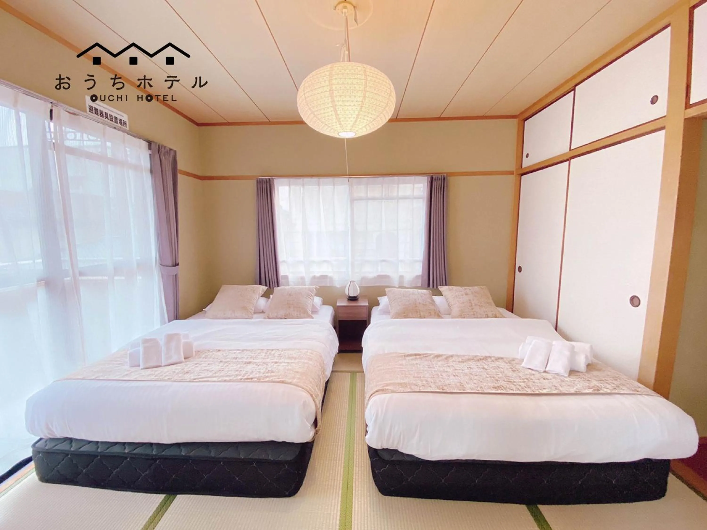 Bed in OUCHI HOTEL Itsukaichi
