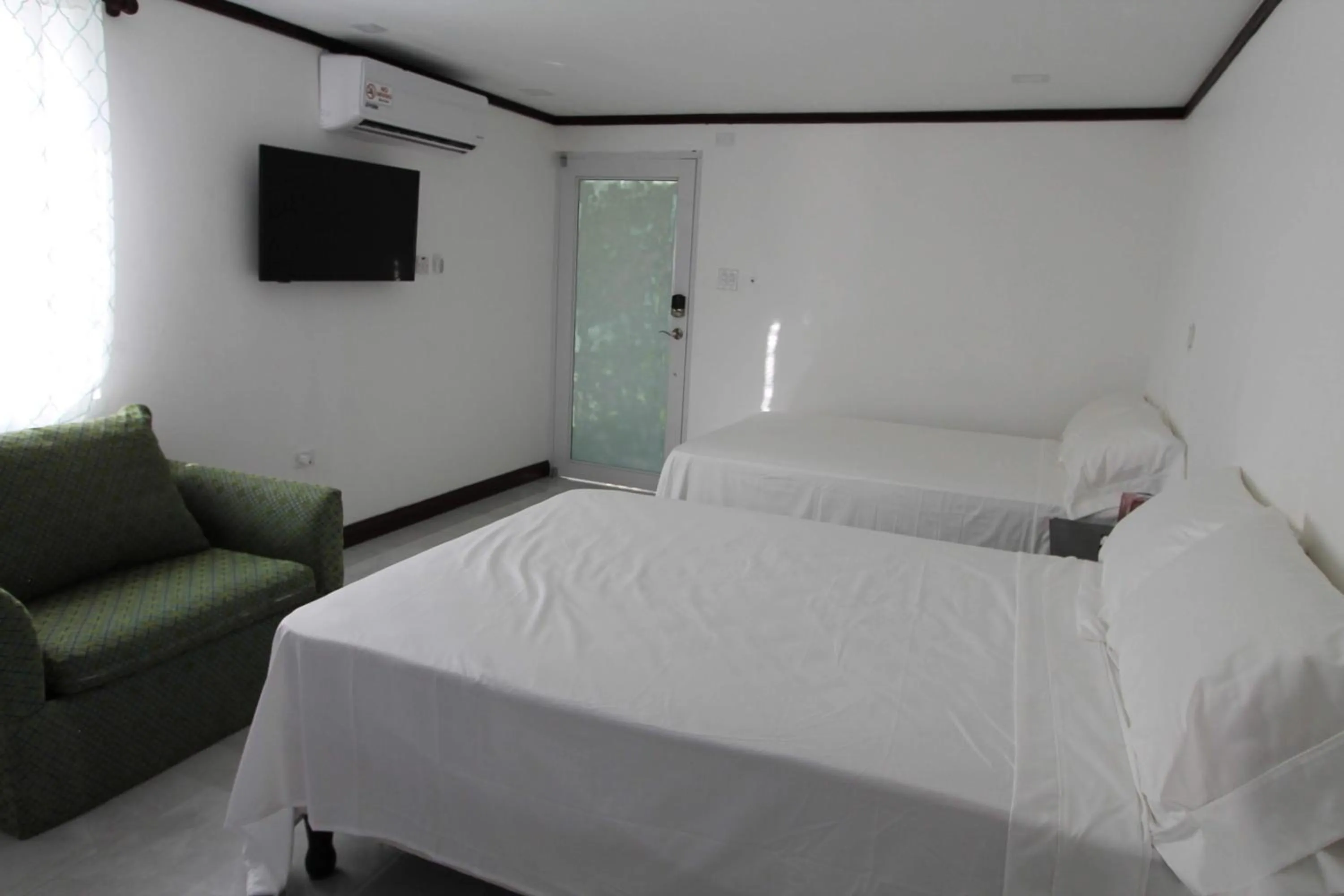 Photo of the whole room, Bed in Sand and Blue Seas