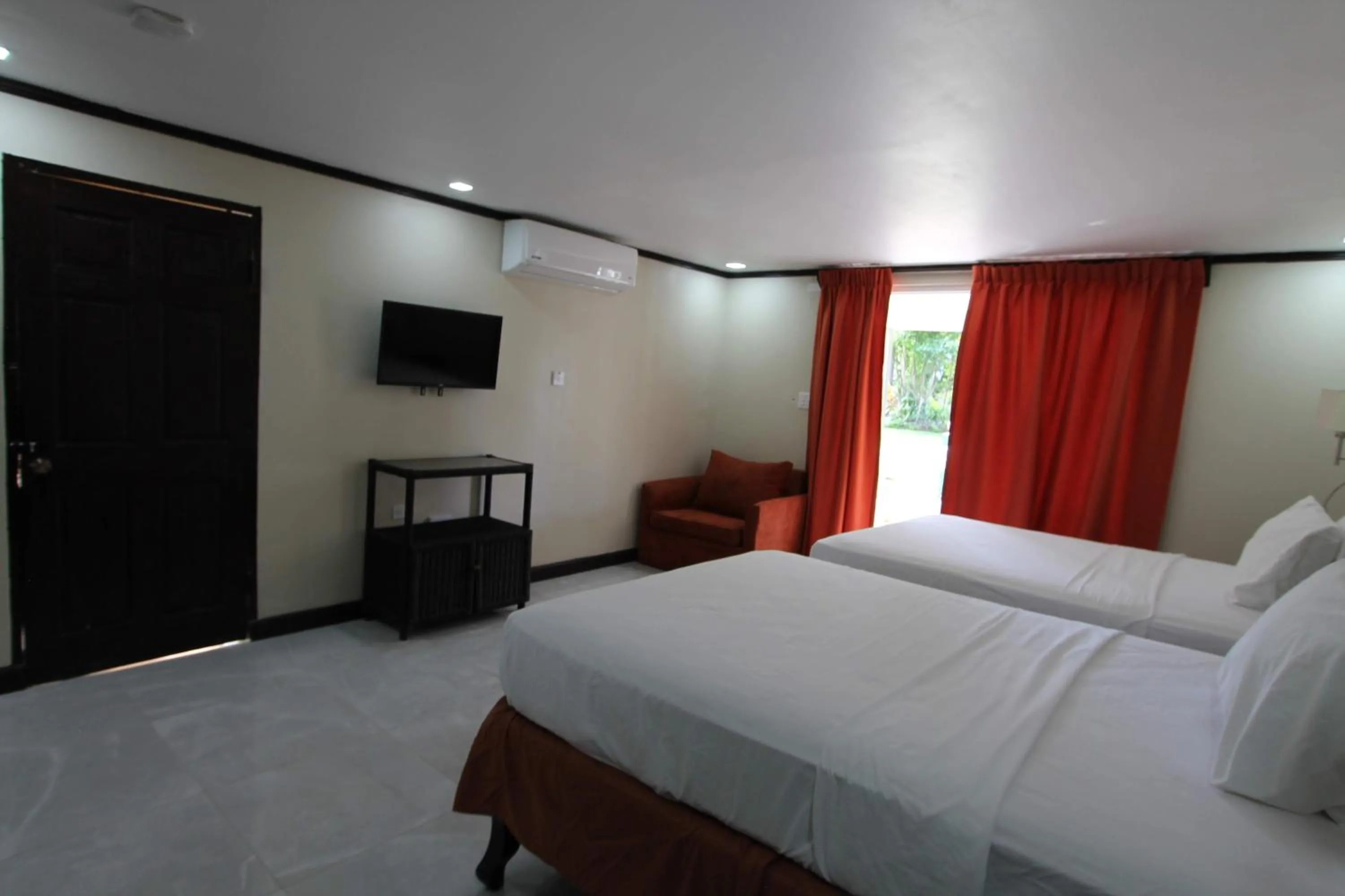 Bed in Sand and Blue Seas