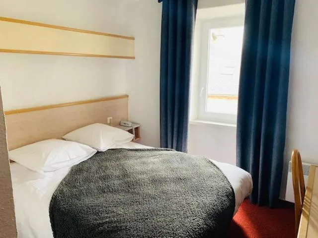 Bedroom in Hôtel-Restaurant La Bergerie