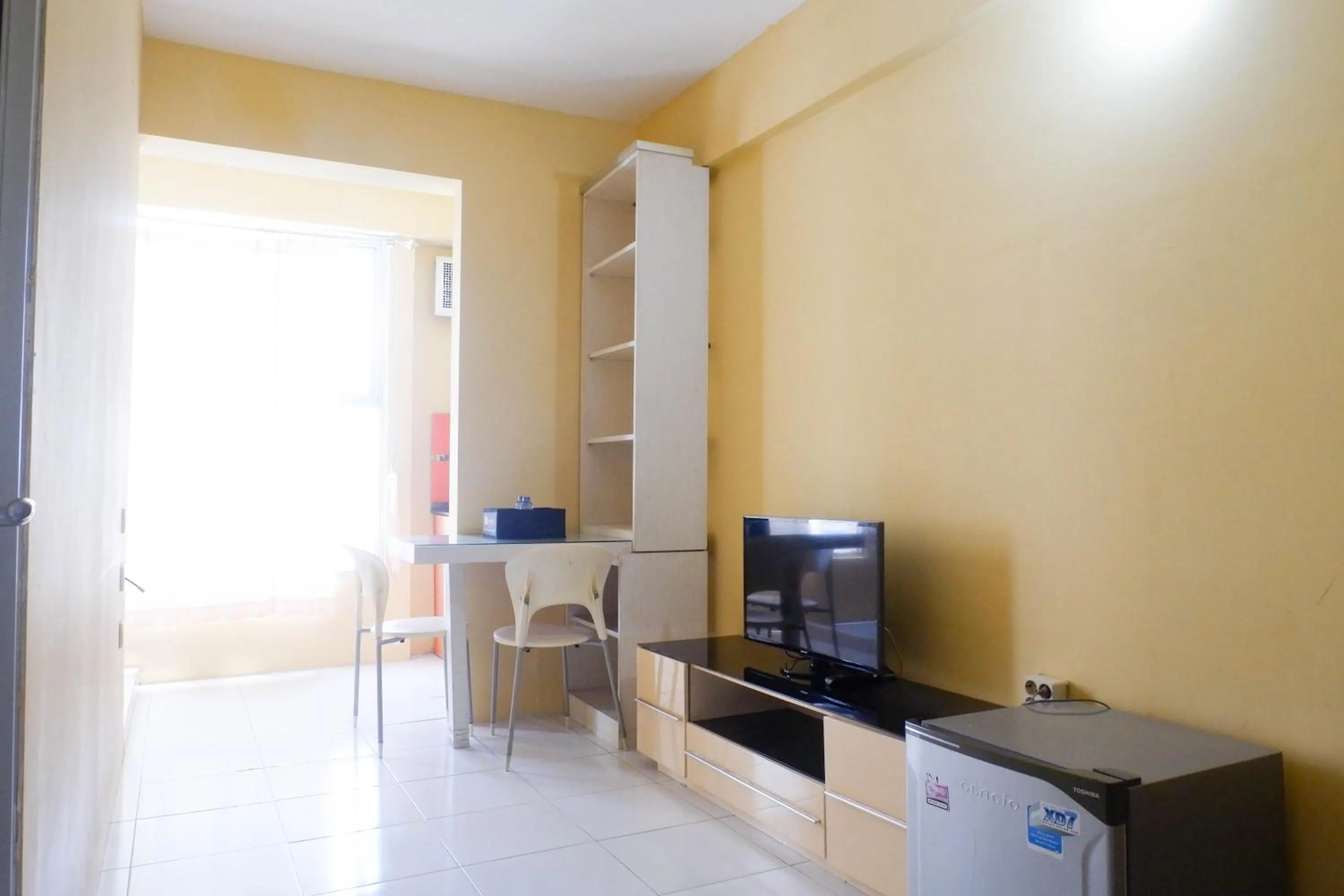 Living room in Minimalist 2BR Apartment at Dian Regency By Travelio
