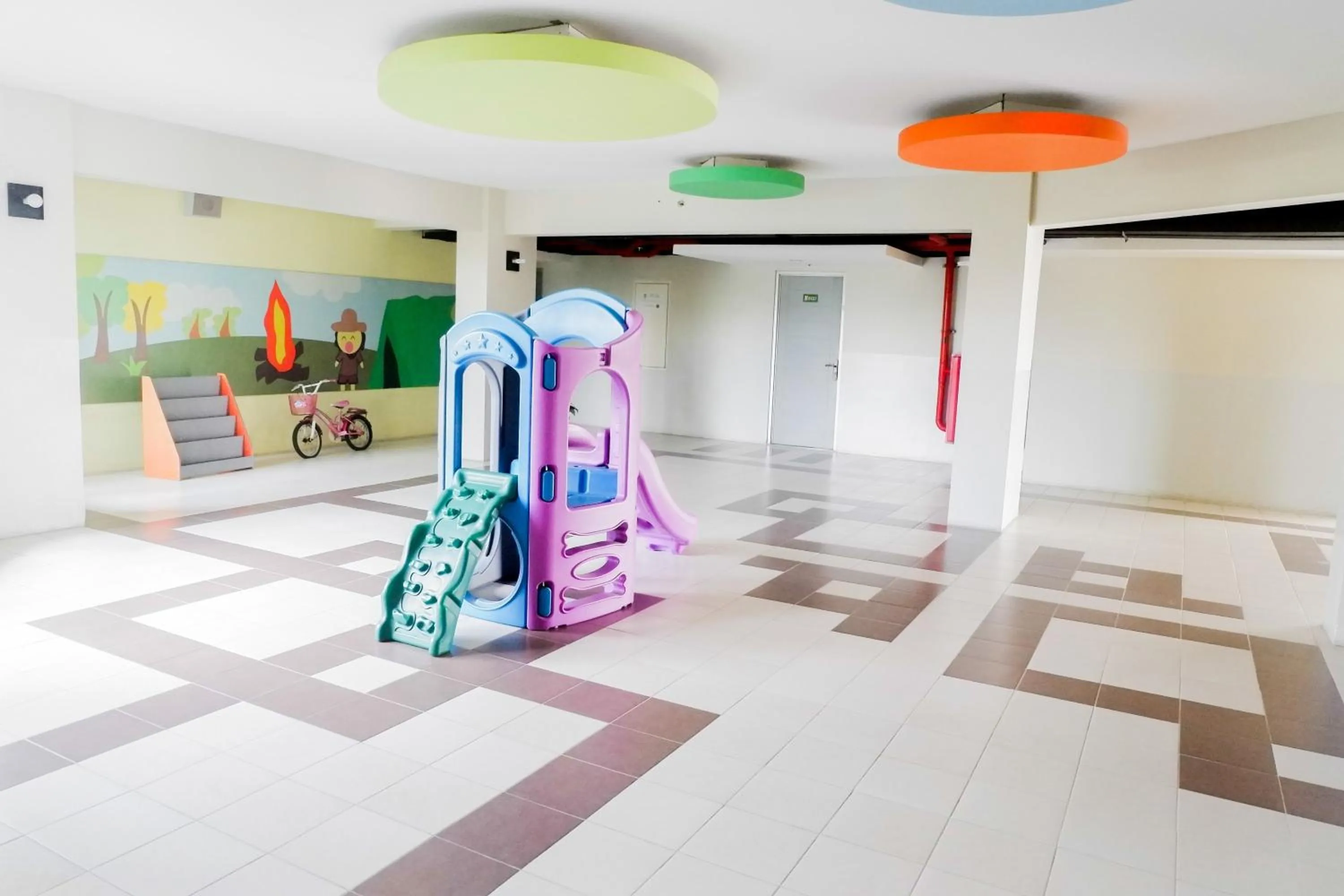 Children play ground in Minimalist 2BR Apartment at Dian Regency By Travelio
