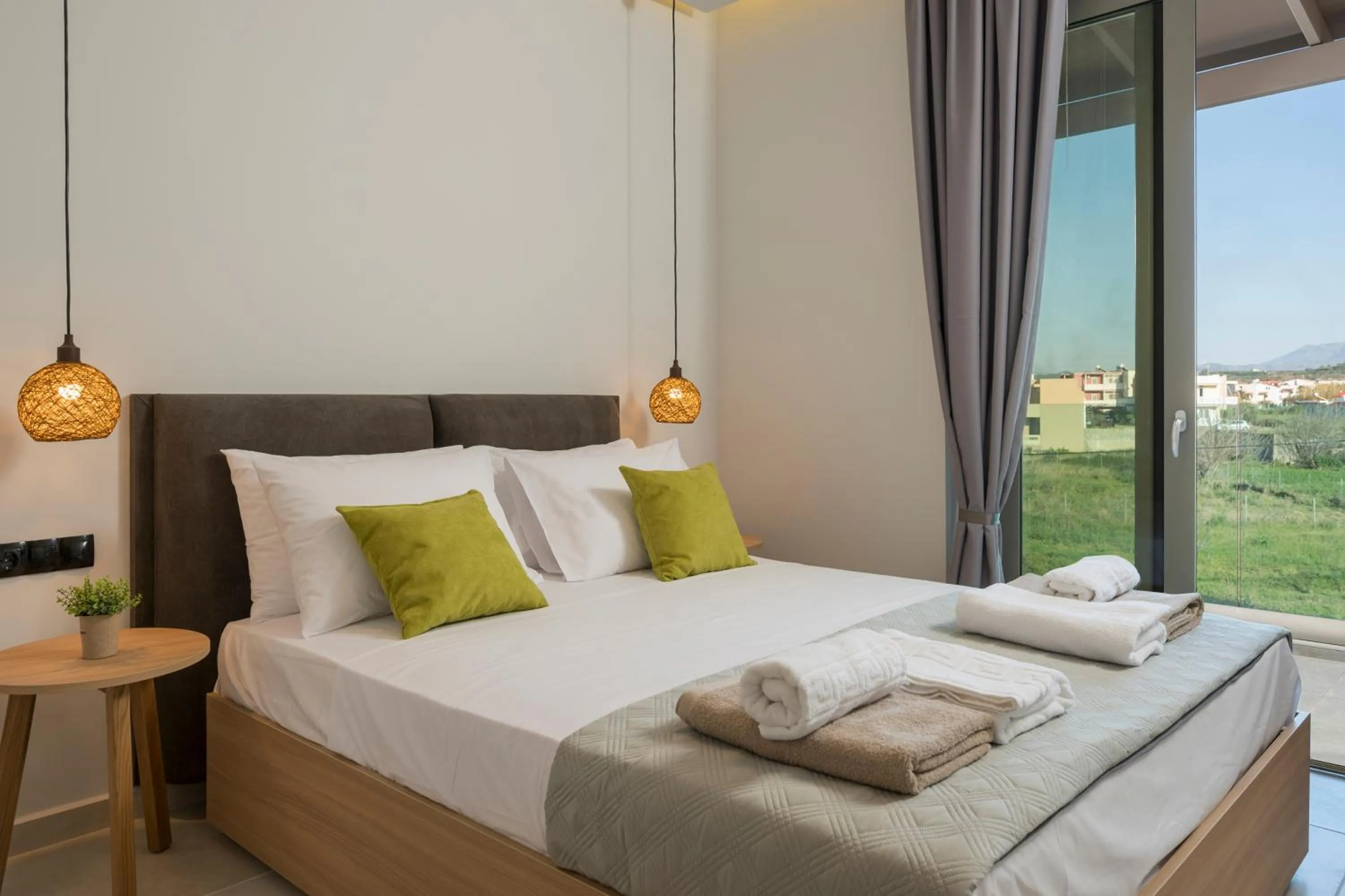 Bed in Aegean Breeze Luxury Apartments next to the sea