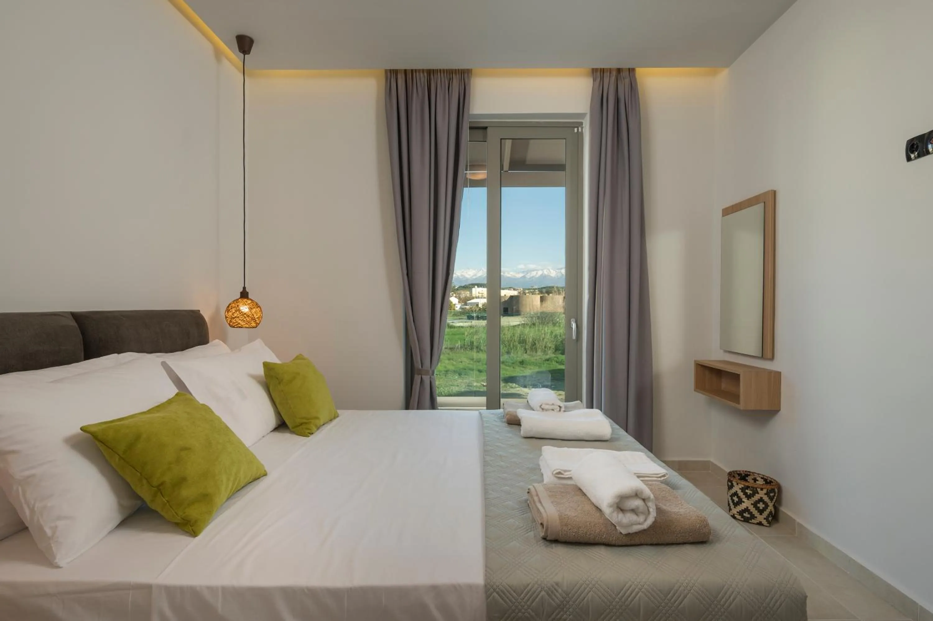 Bed in Aegean Breeze Luxury Apartments next to the sea