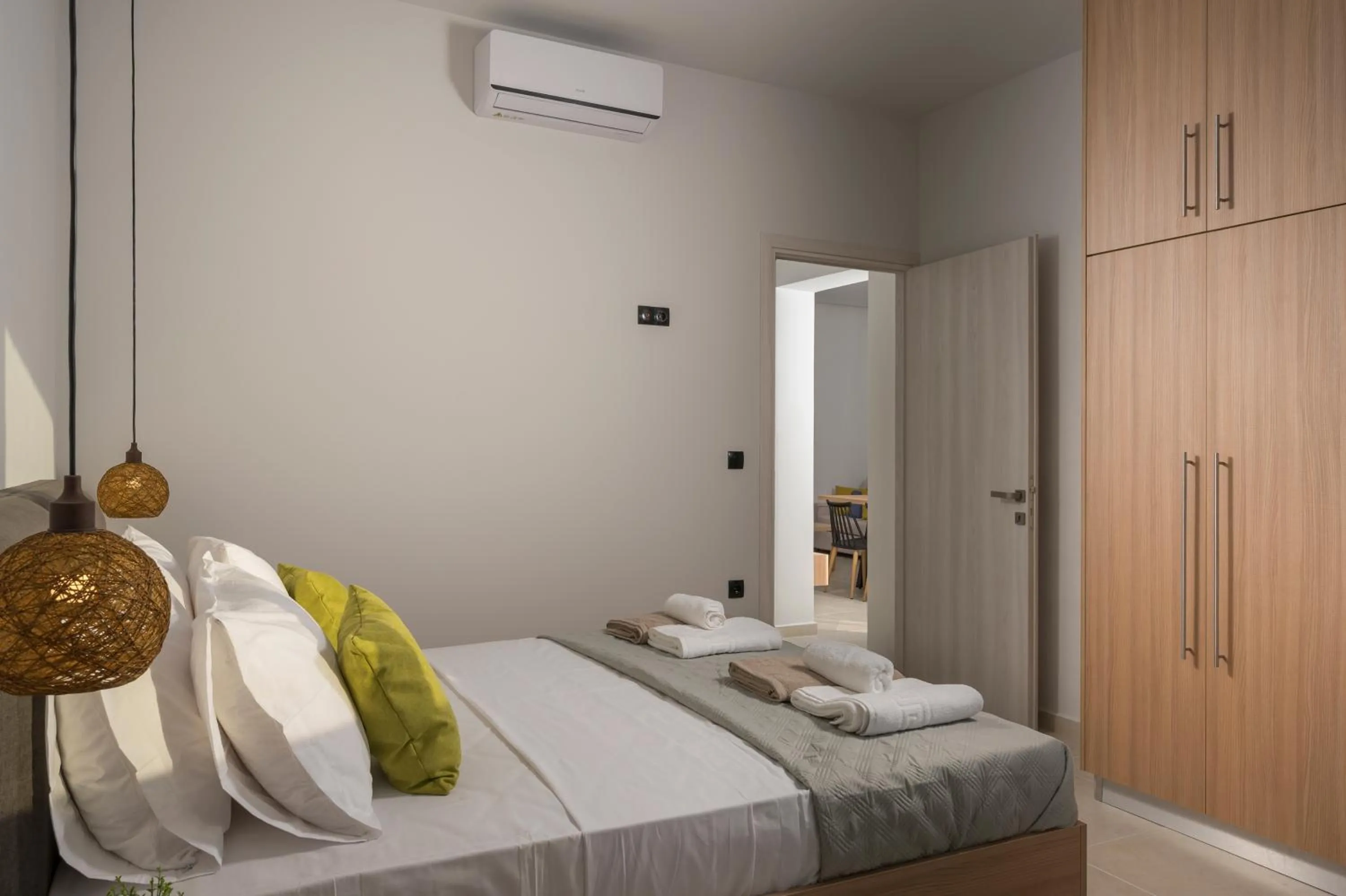 Bed in Aegean Breeze Luxury Apartments next to the sea
