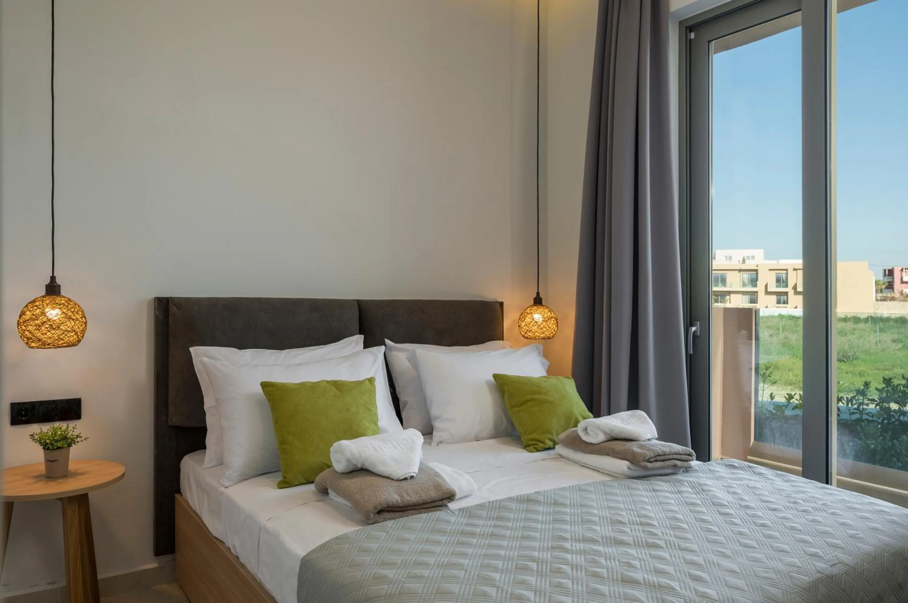 Bed in Aegean Breeze Luxury Apartments next to the sea