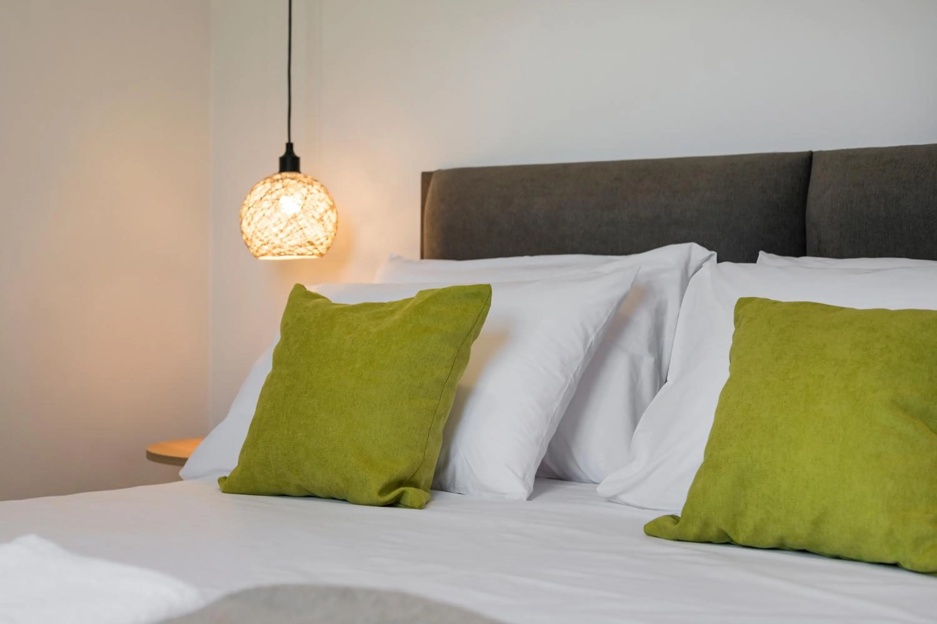 Bed in Aegean Breeze Luxury Apartments next to the sea