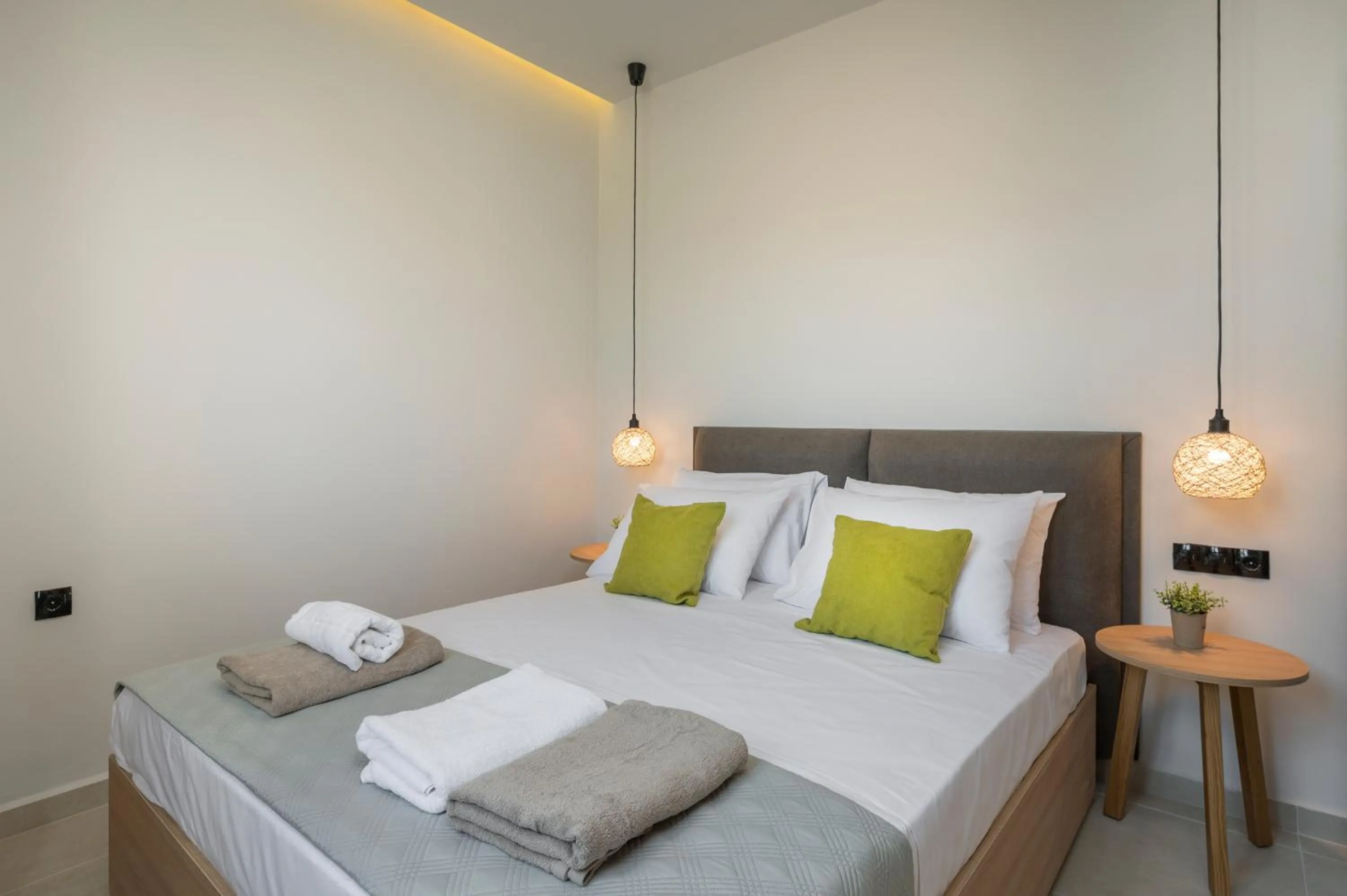 Bed in Aegean Breeze Luxury Apartments next to the sea